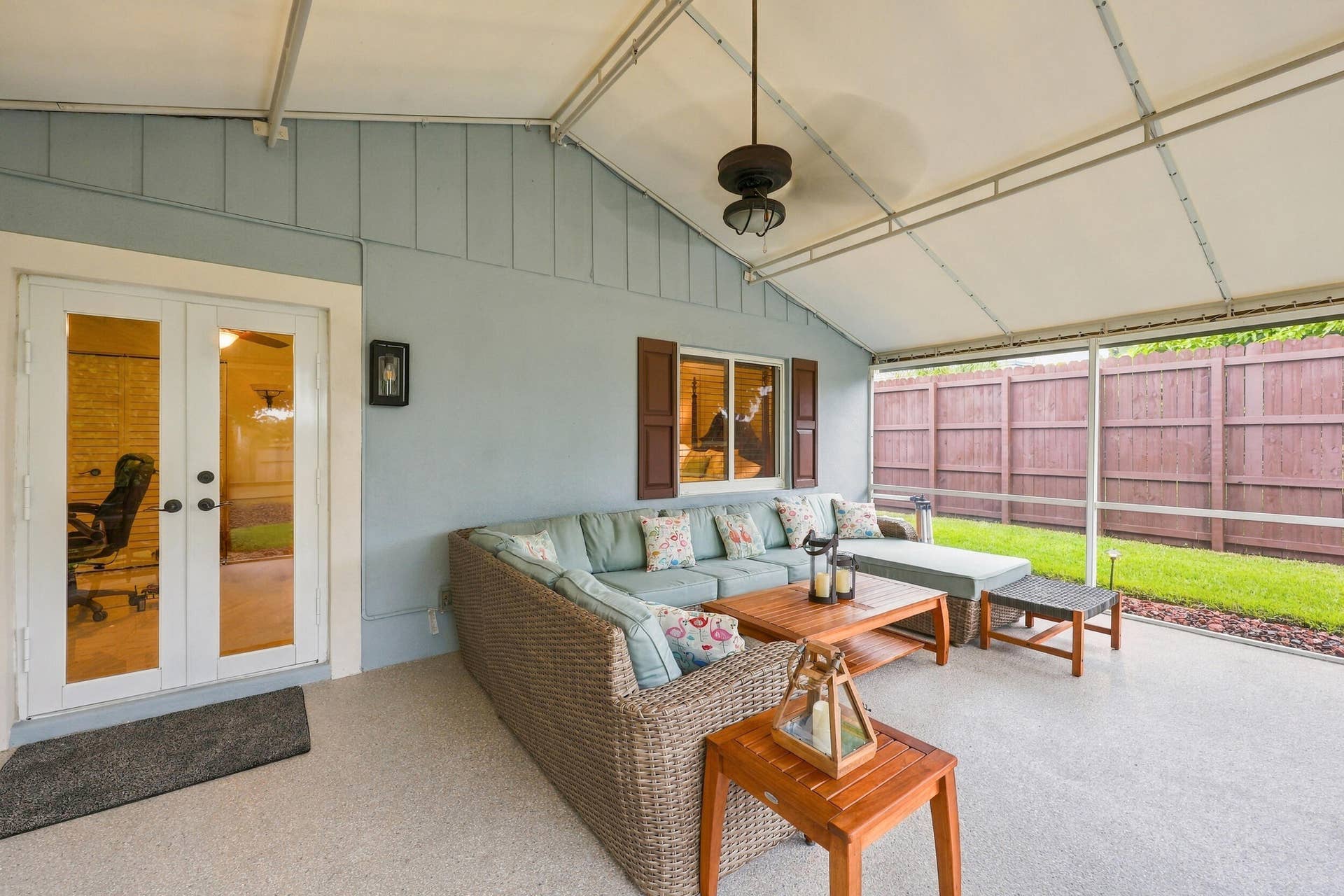 3590 Lakeview Drive, Delray Beach, FL 33445 A living room outside is highlighted by vaulted ceilings, a privacy fence, views of Lakeview Golf Course, and a versatile area to entertain.