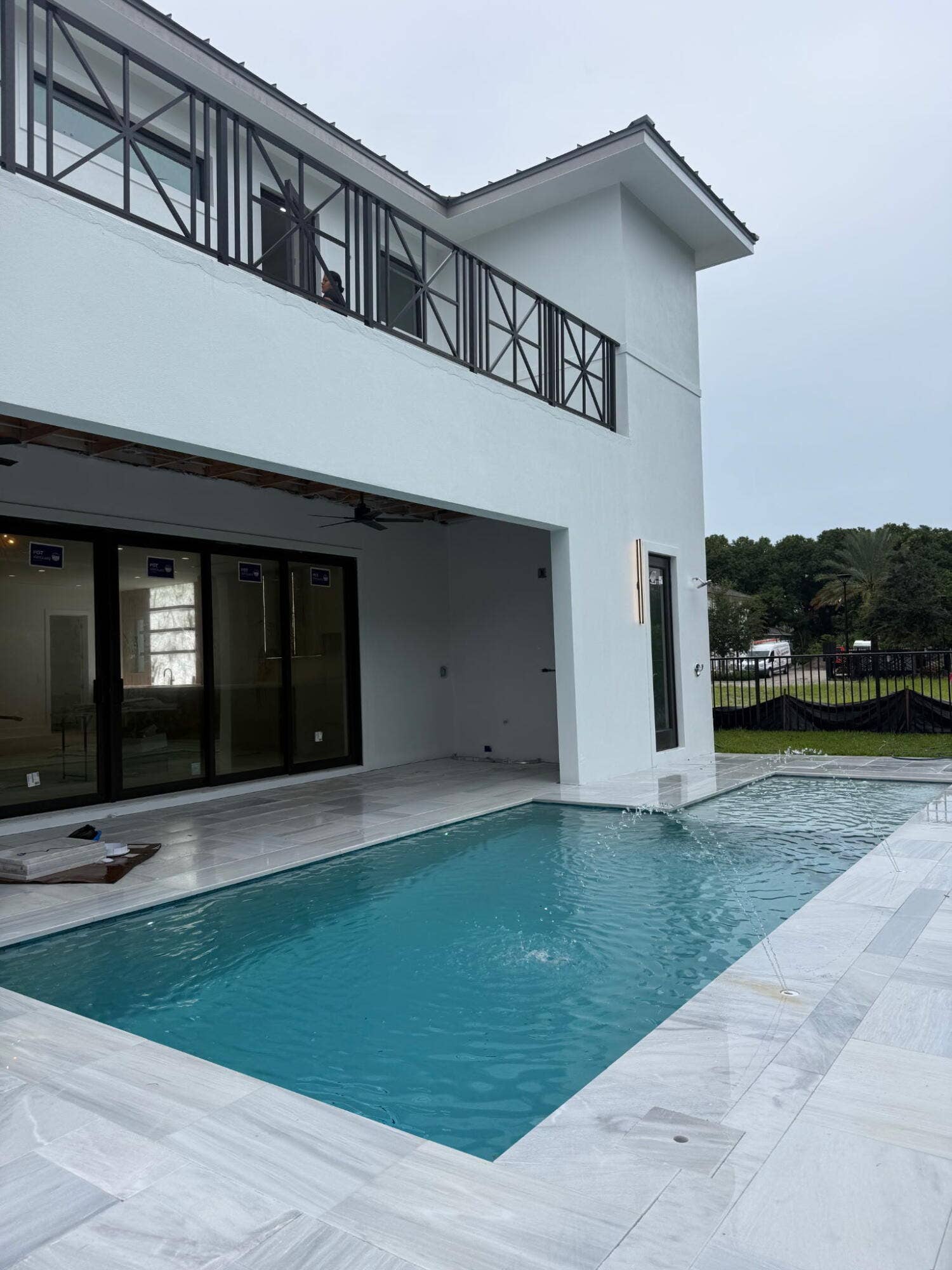 1109 PROSPERITY VILLAGE Drive, North Palm Beach, FL 33410 Two-tier swimming pool with an integrated spa, surrounded by white stone pavers