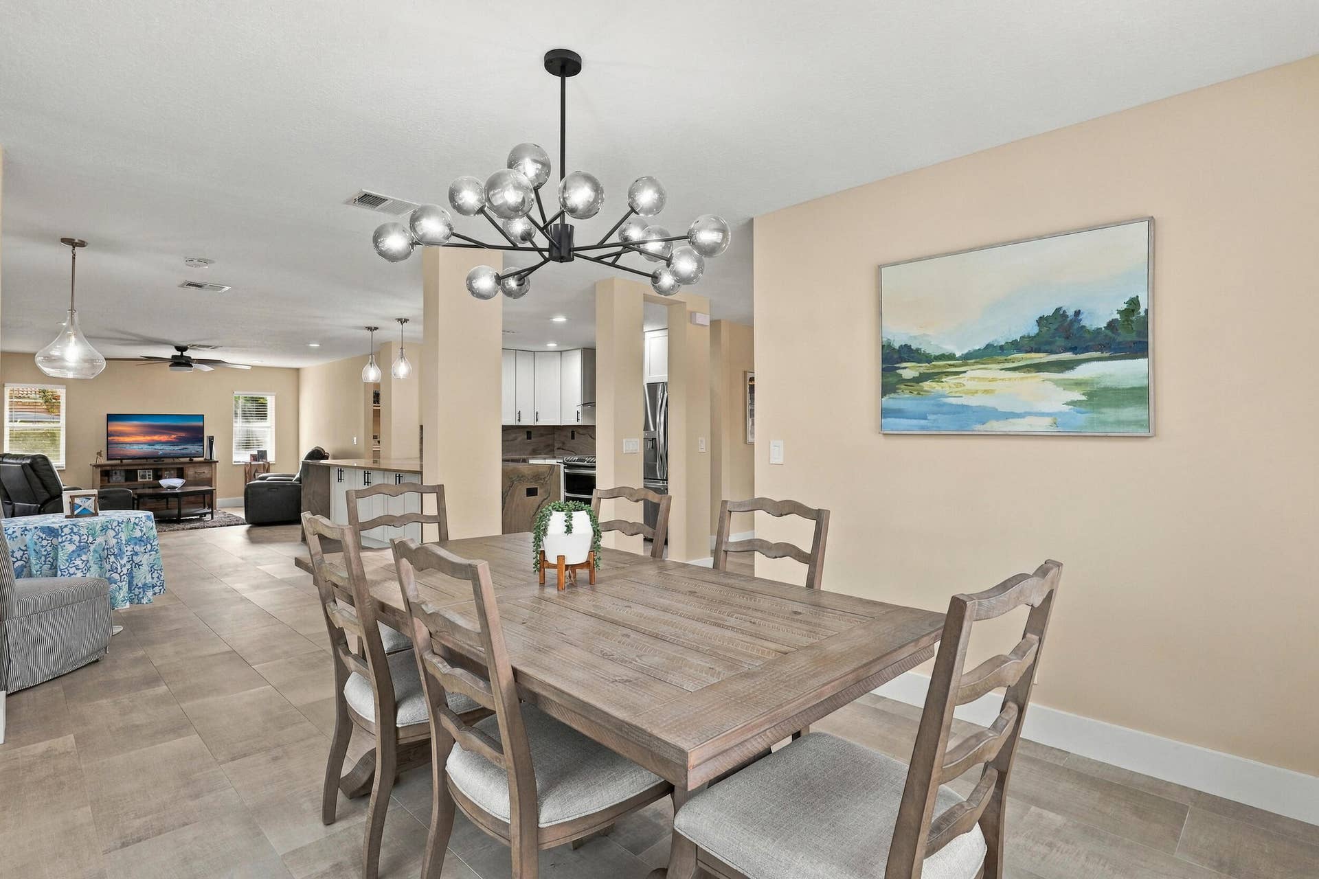 1434 Artimino Lane, Boynton Beach, FL 33436 The formal dining room is wrapped in an abundance of light from two oversized windows and highlighted by a designer chandelier.