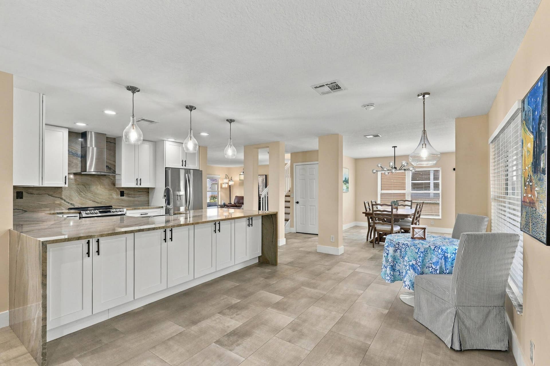1434 Artimino Lane, Boynton Beach, FL 33436 The enormous kitchen peninsula provides tons of additional storage, a great place to gather and eat within the kitchen, and is highlighted by a magnificent piece of natural quartzite stone.