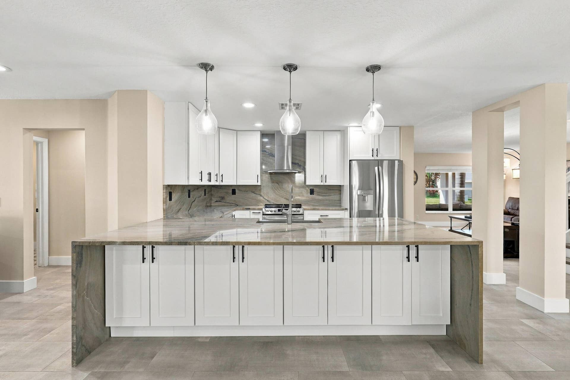 1434 Artimino Lane, Boynton Beach, FL 33436 The enormous kitchen peninsula provides tons of additional storage, a great place to gather and eat within the kitchen, and is highlighted by a magnificent piece of natural quartzite stone.