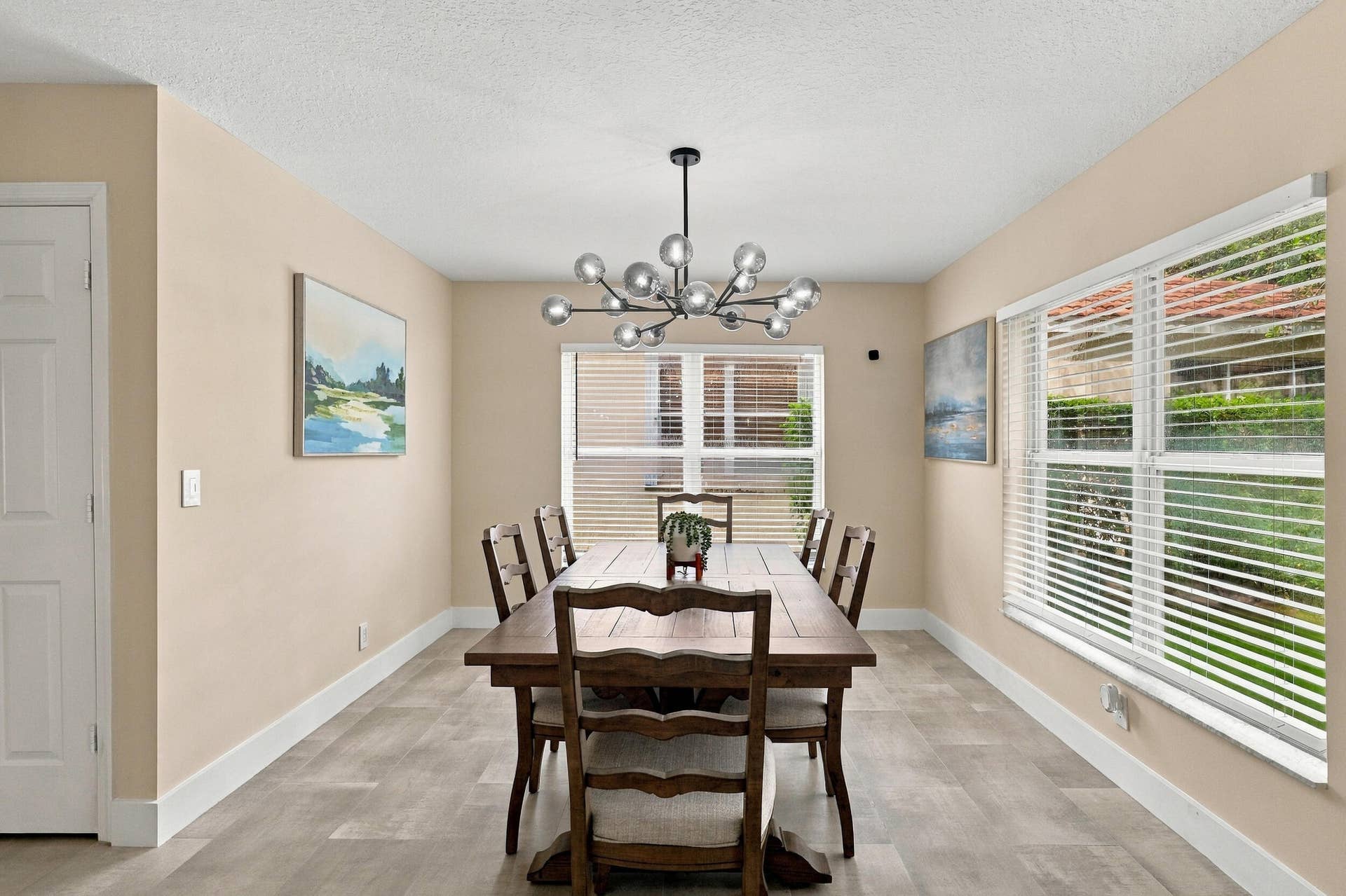 1434 Artimino Lane, Boynton Beach, FL 33436 The formal dining room is wrapped in an abundance of light from two oversized windows and highlighted by a designer chandelier.