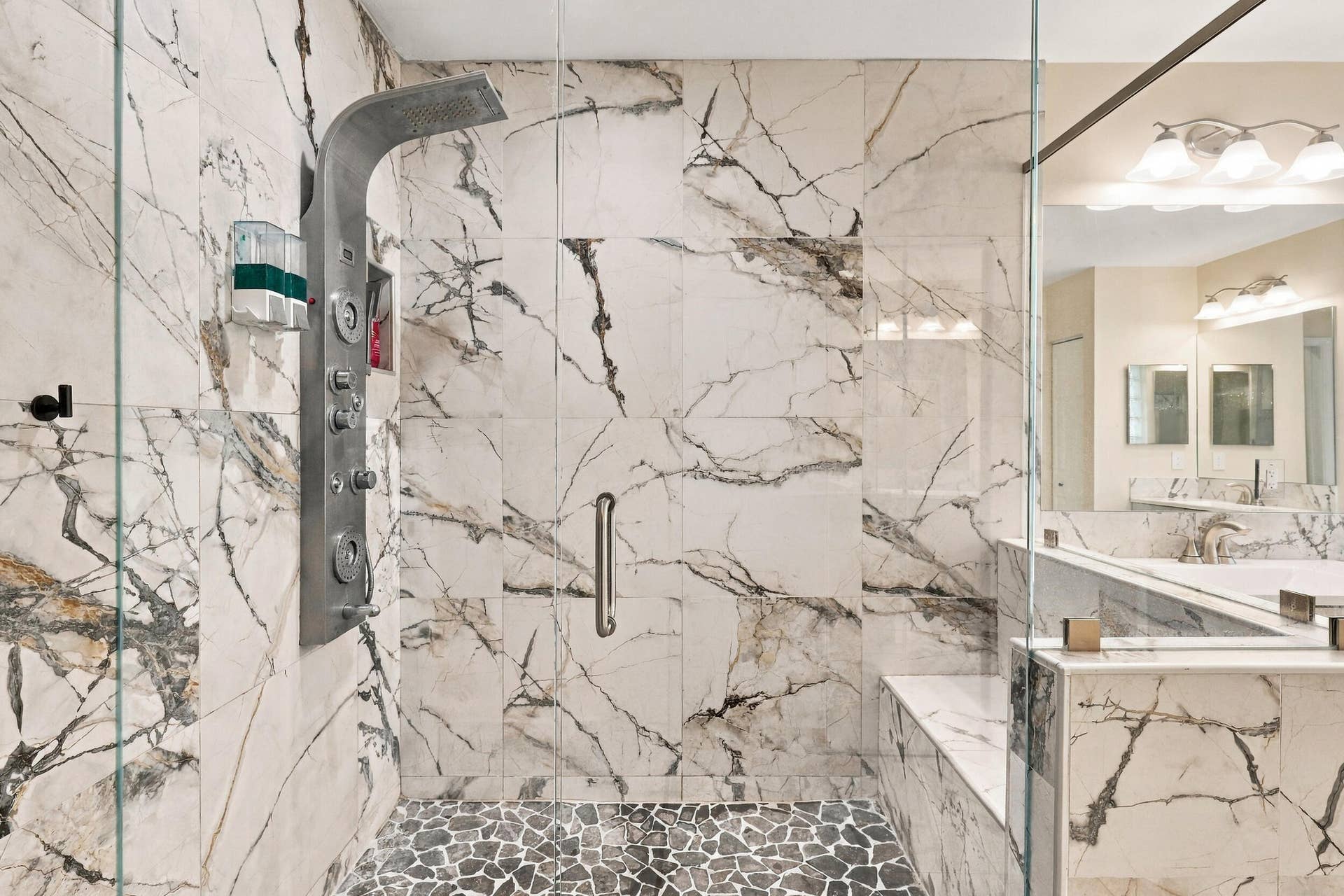 1434 Artimino Lane, Boynton Beach, FL 33436 The primary bathroom rivals any five-star spa with a dramatic and elegant, frameless, marble glass shower matching the floors of the bathroom.
