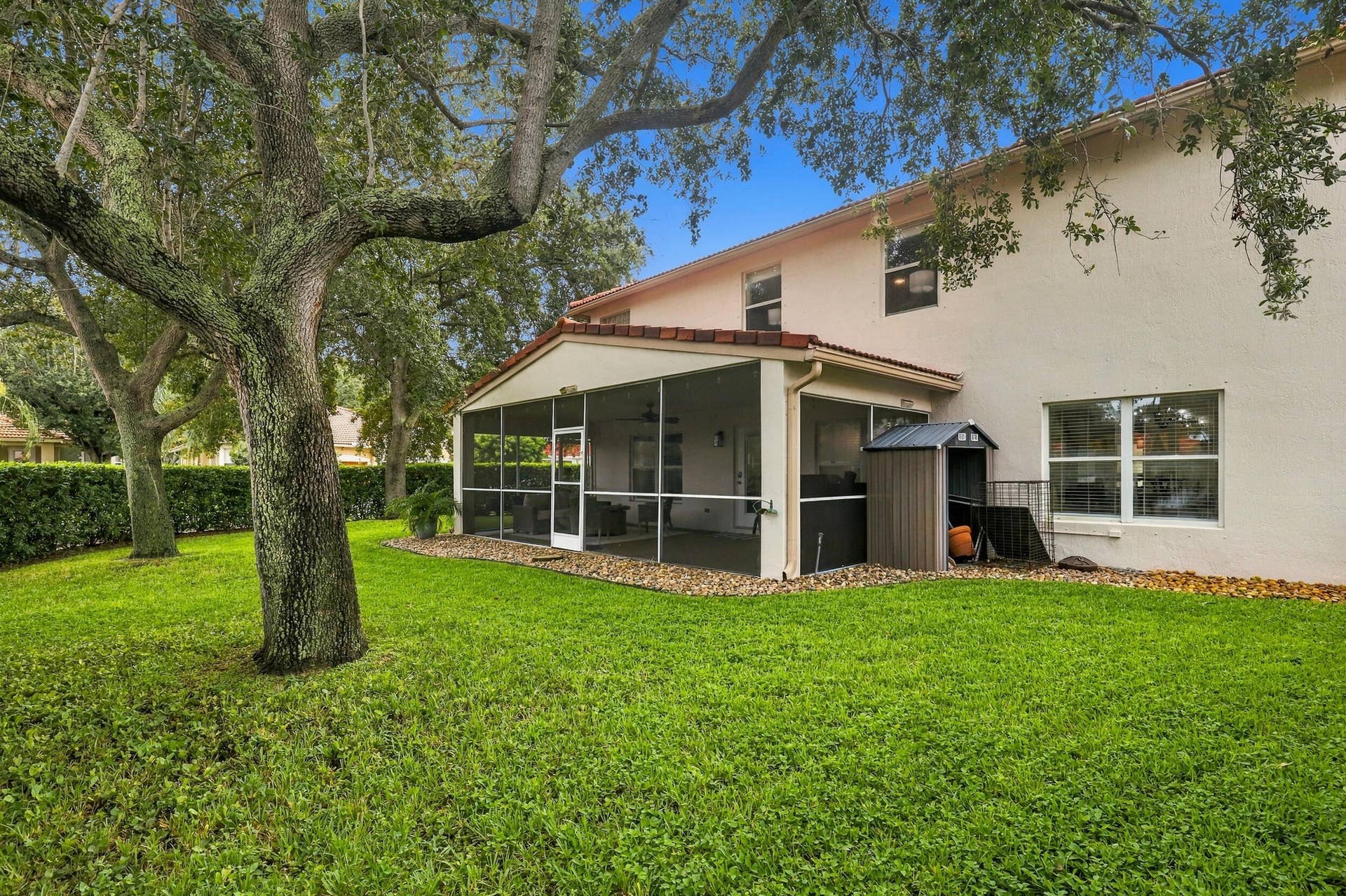1434 Artimino Lane, Boynton Beach, FL 33436 A 360 square foot covered and screened patio dramatically expands the home's entertaining space, with plenty of room to create both an outdoor living room and dining area for year round enjoyment. Whether hosting family and friends, dining outside, or simply unwinding at the end of the day, the combination of the expansive screened patio, lush hedges, full fencing, and complete rear privacy makes this a truly special outdoor setting.