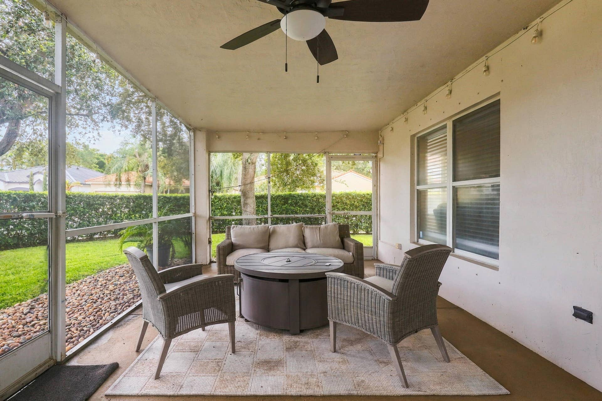 1434 Artimino Lane, Boynton Beach, FL 33436 A 360 square foot covered and screened patio dramatically expands the home's entertaining space, with plenty of room to create both an outdoor living room and dining area for year round enjoyment. Whether hosting family and friends, dining outside, or simply unwinding at the end of the day, the combination of the expansive screened patio, lush hedges, full fencing, and complete rear privacy makes this a truly special outdoor setting.