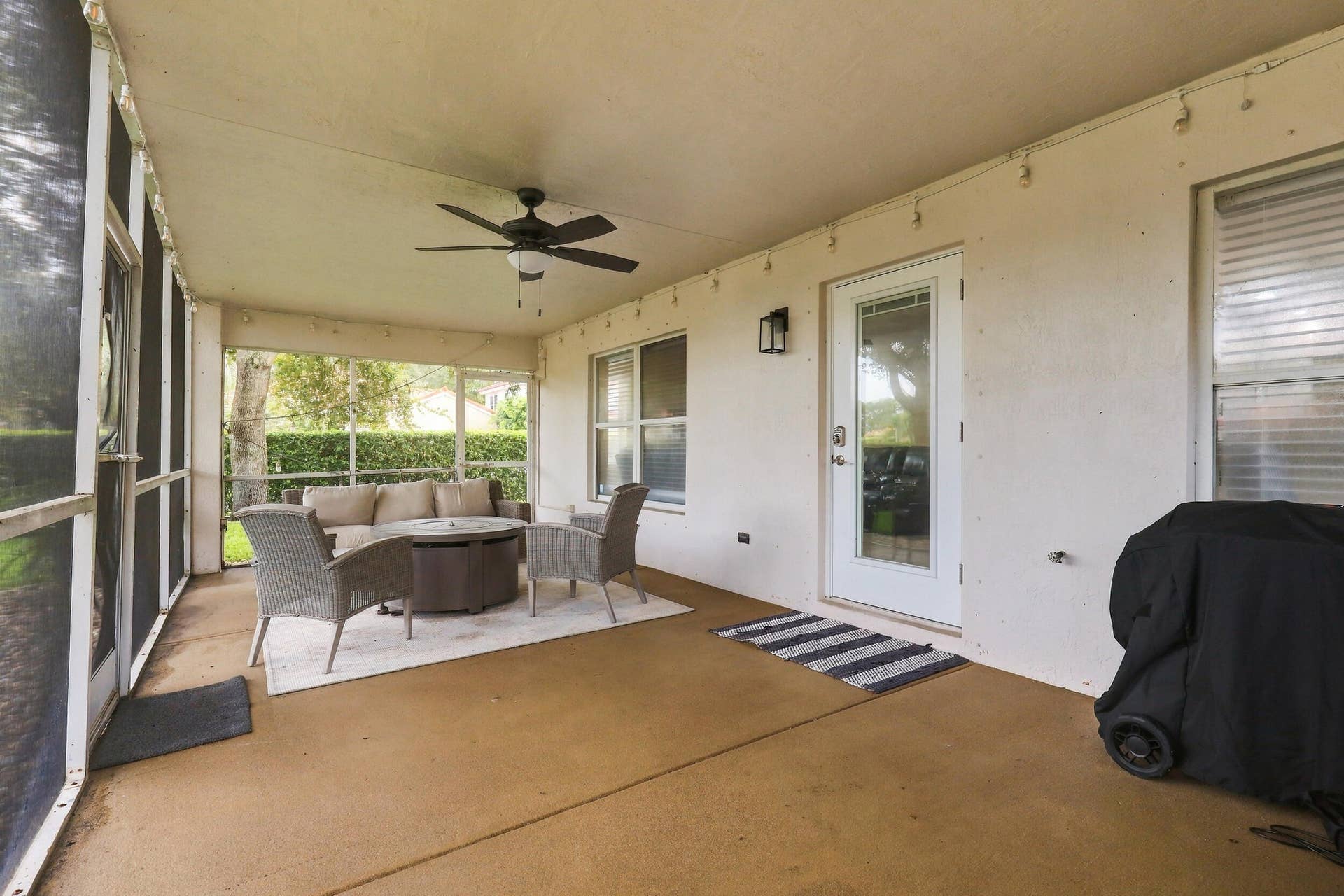 1434 Artimino Lane, Boynton Beach, FL 33436 A 360 square foot covered and screened patio dramatically expands the home's entertaining space, with plenty of room to create both an outdoor living room and dining area for year round enjoyment. Whether hosting family and friends, dining outside, or simply unwinding at the end of the day, the combination of the expansive screened patio, lush hedges, full fencing, and complete rear privacy makes this a truly special outdoor setting.