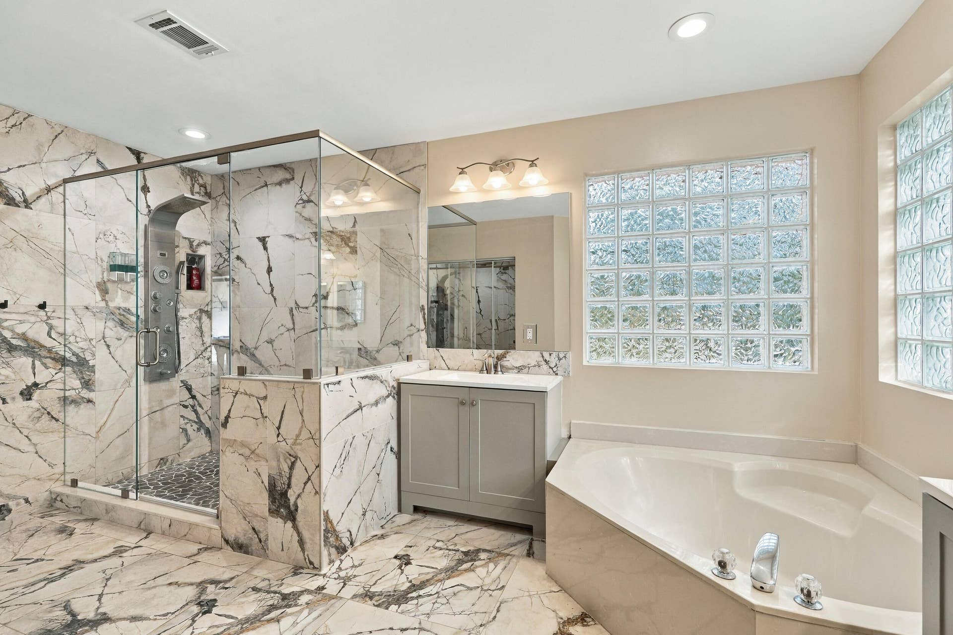 1434 Artimino Lane, Boynton Beach, FL 33436 The primary bathroom rivals any five-star spa with a dramatic and elegant, frameless, marble glass shower matching the floors of the bathroom.