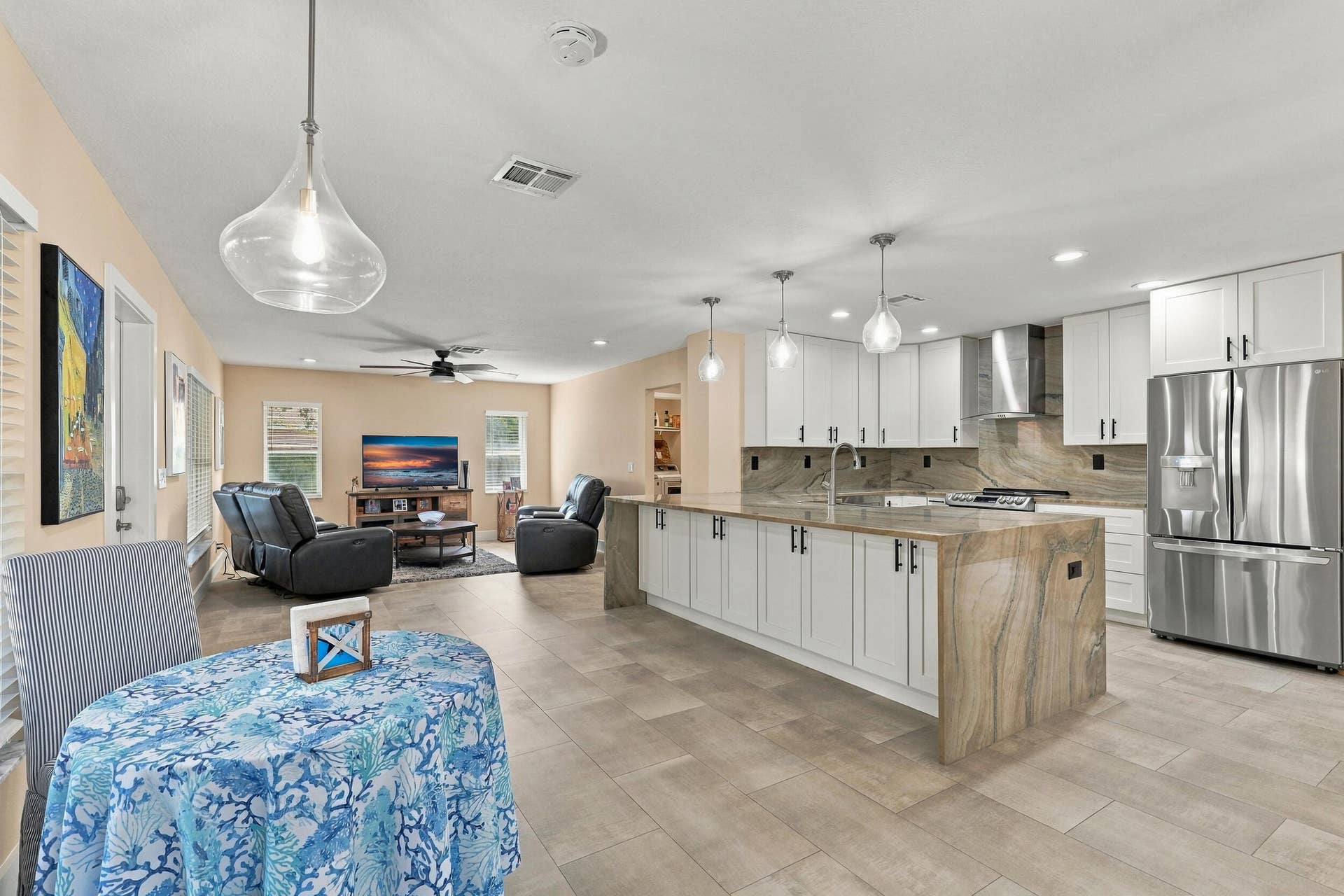 1434 Artimino Lane, Boynton Beach, FL 33436 The heart of the home is the exquisite renovated kitchen, featuring white Shaker style cabinetry, stunning quartzite countertops and backsplash, stainless steel appliances, designer lighting, abundant storage, and an oversized island that creates an impressive centerpiece for everyday living and entertaining. The open layout flows effortlessly into the main living areas and breakfast nook, while a separate dining space provides plenty of room for gatherings.