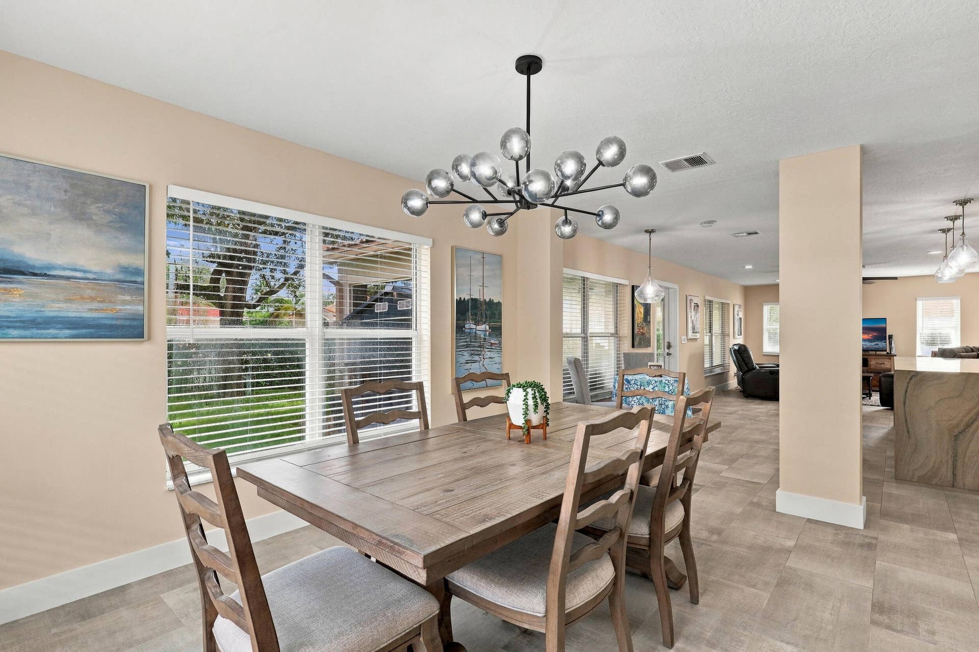 1434 Artimino Lane, Boynton Beach, FL 33436 The formal dining room is wrapped in an abundance of light from two oversized windows and highlighted by a designer chandelier.