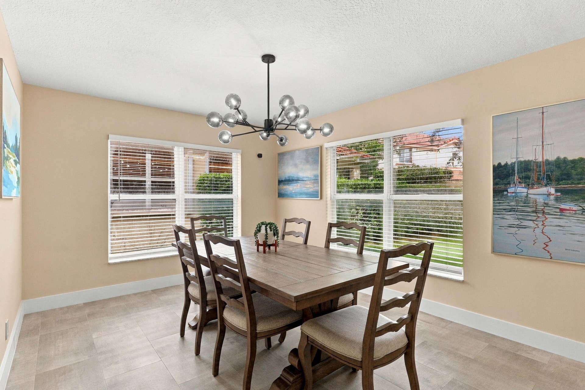 1434 Artimino Lane, Boynton Beach, FL 33436 The formal dining room is wrapped in an abundance of light from two oversized windows and highlighted by a designer chandelier.