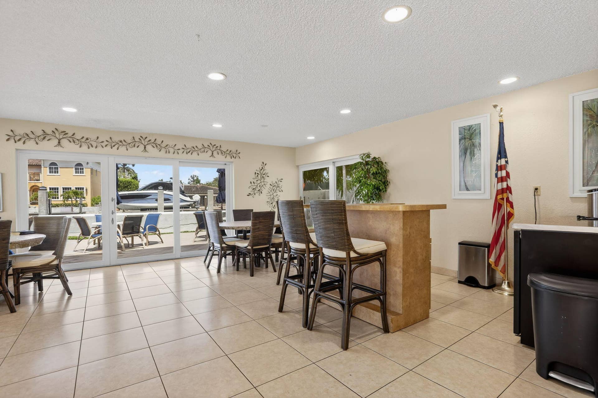 Rec center off pool with indoor/outdoor seating, kitchen, grill, bathrooms