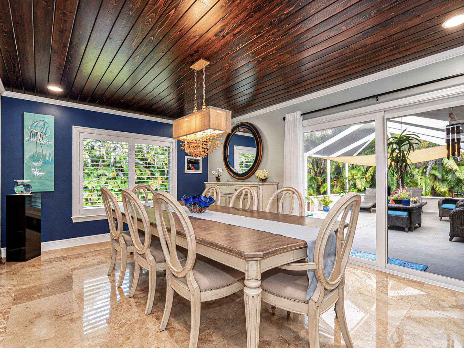 215 8TH Terrace, Vero Beach, FL 32962 Wood-plank ceiling with impact sliding glass doors opening to an enclosed patio.
