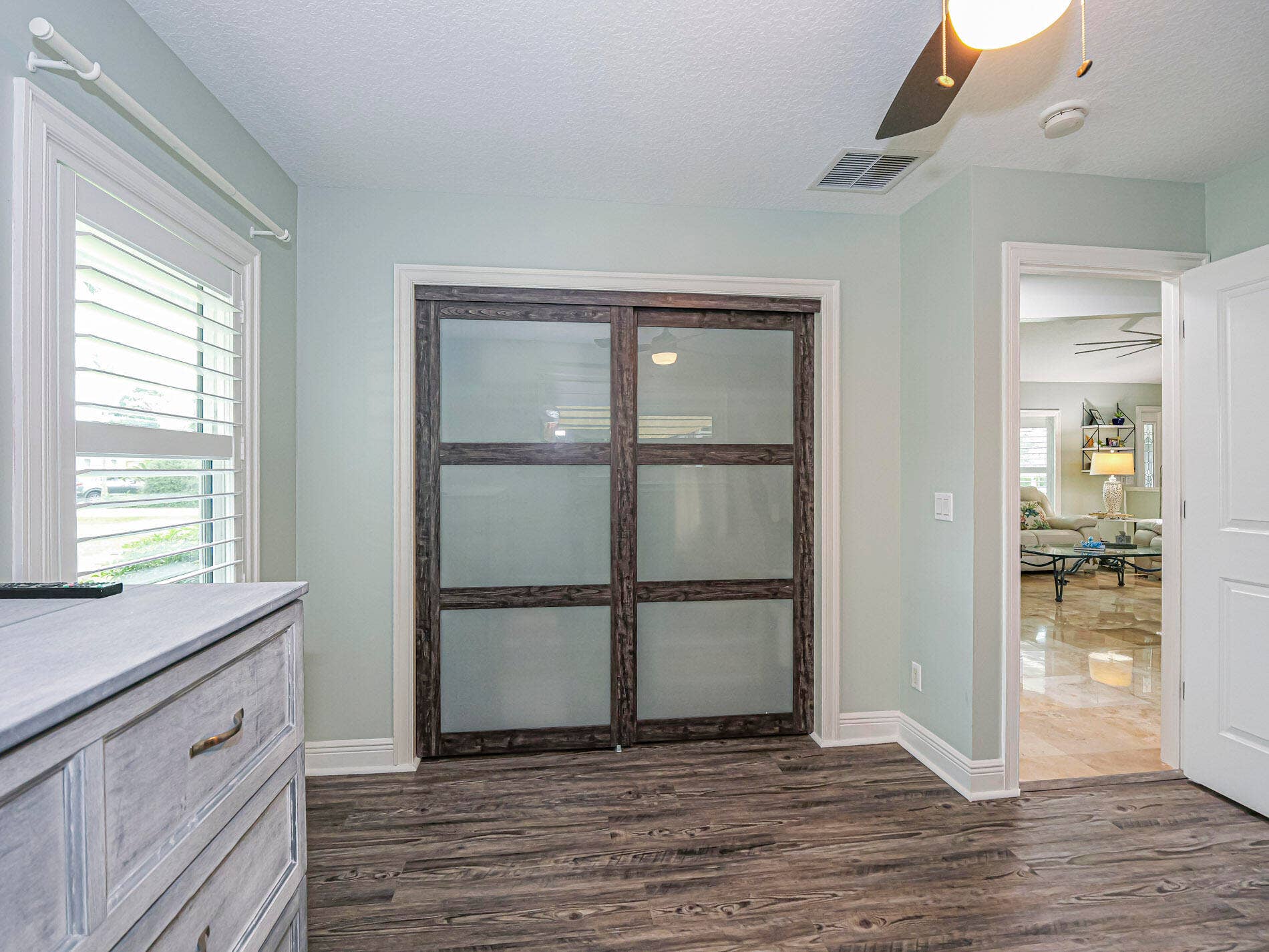 215 8TH Terrace, Vero Beach, FL 32962 Third Bedroom close with custom frosted glass closet doors.