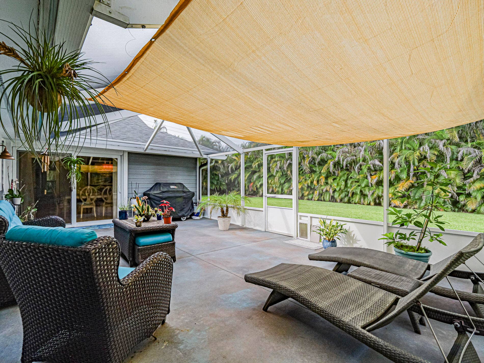 215 8TH Terrace, Vero Beach, FL 32962 Private Screened patio with a fabric shade structure.