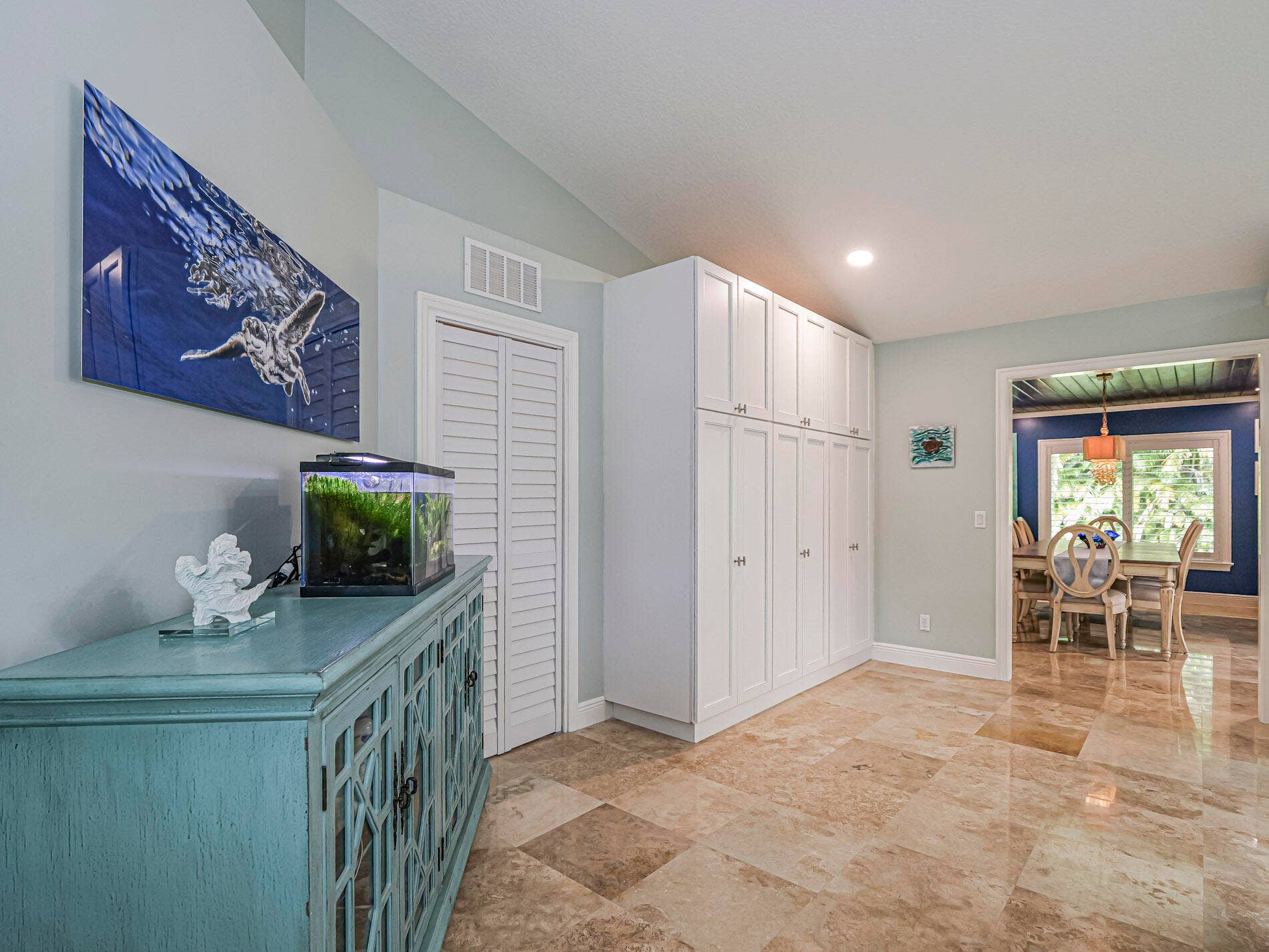 215 8TH Terrace, Vero Beach, FL 32962 Vaulted ceiling, full-height built-in cabinetry, bi-fold closet doors, tile flooring, and a cased opening