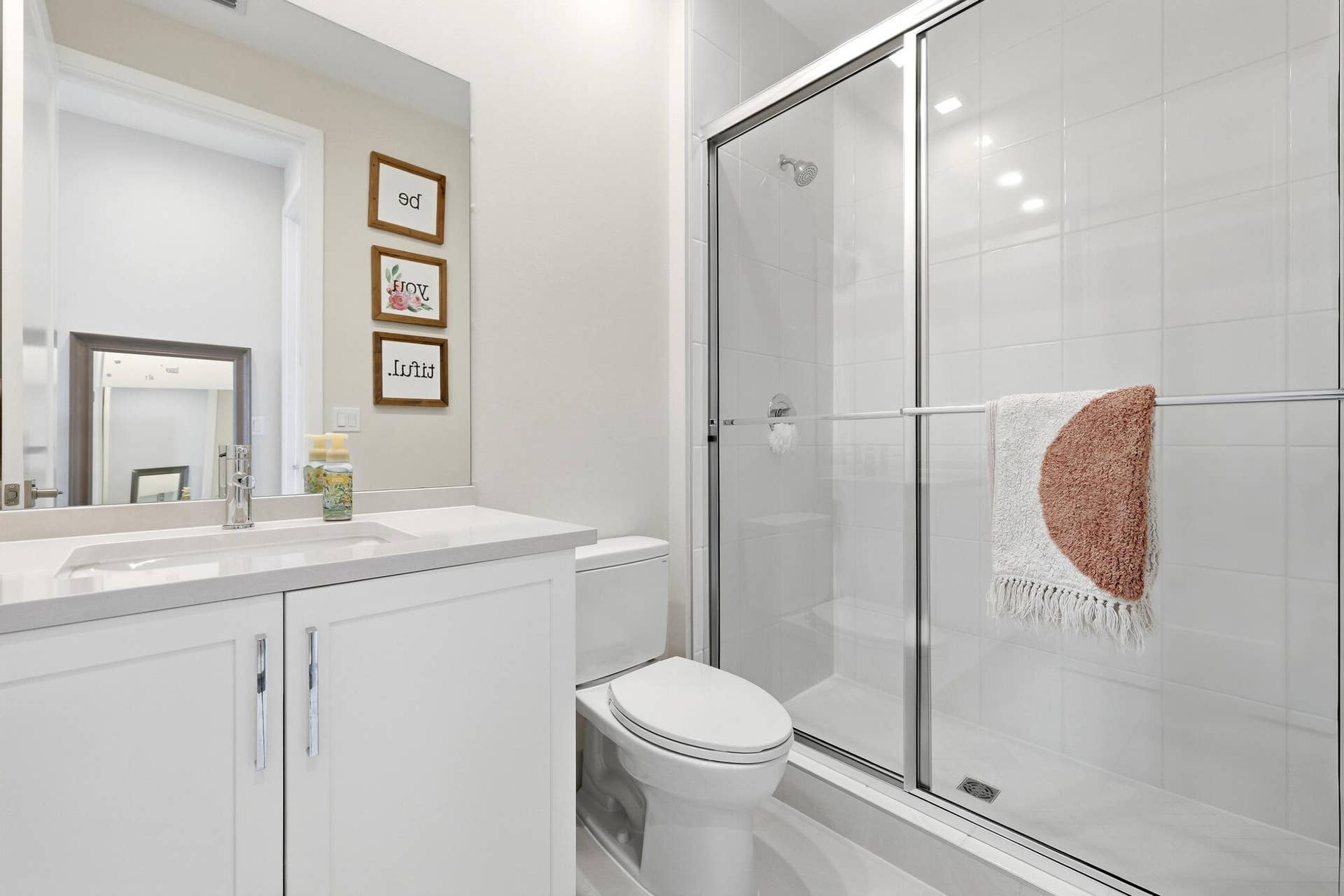 White vanity with an integrated sink, polished chrome faucet, and spacious countertop