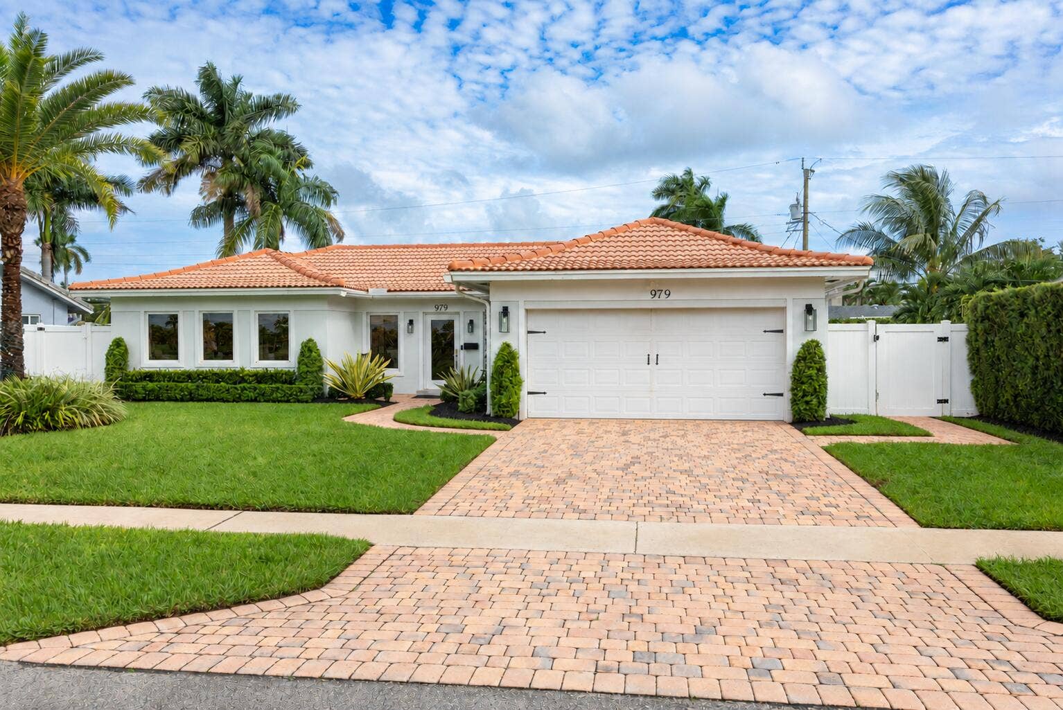 979 SW 13TH Drive, Boca Raton, FL 33486 Paver driveway and landscaped front lawn.