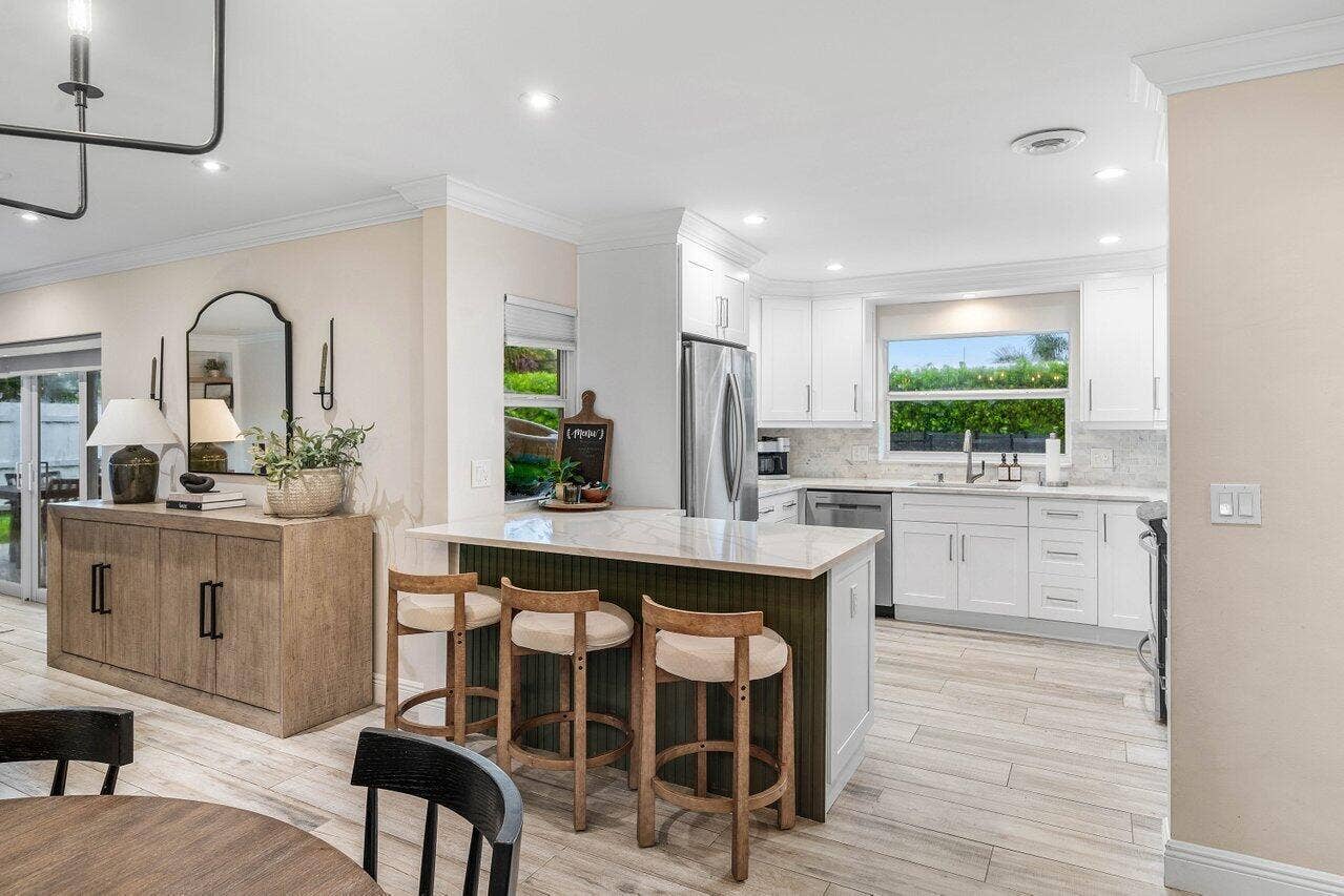 979 SW 13TH Drive, Boca Raton, FL 33486 White cabinetry and breakfast bar seating.