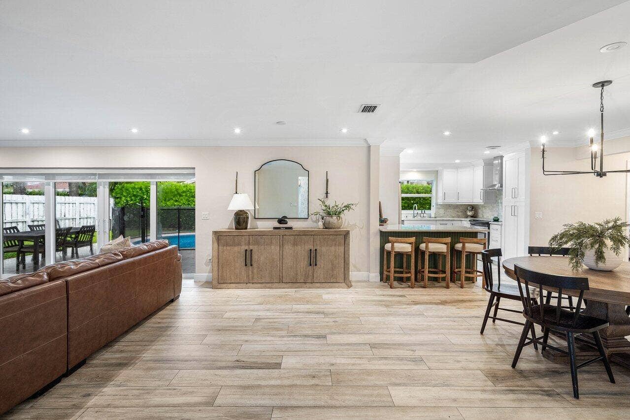 979 SW 13TH Drive, Boca Raton, FL 33486 An open layout connects the living room, dining area, and kitchen.