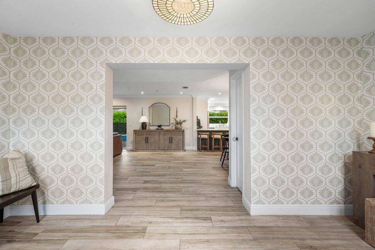 979 SW 13TH Drive, Boca Raton, FL 33486 A wide opening connects the foyer to the homes open living space.