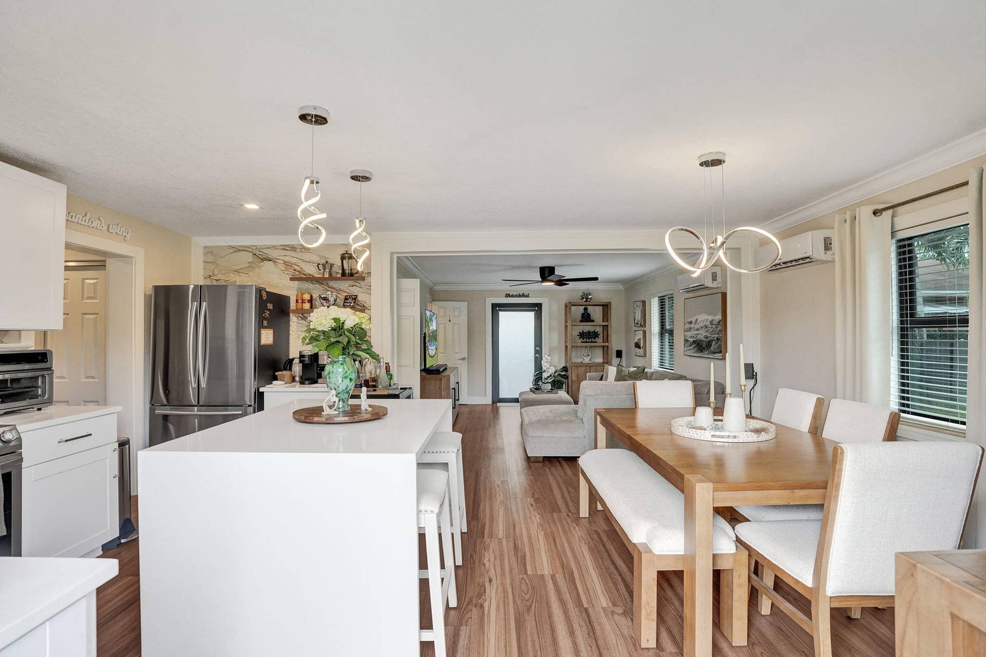 Kitchen island with snack bar and adjacent dining area