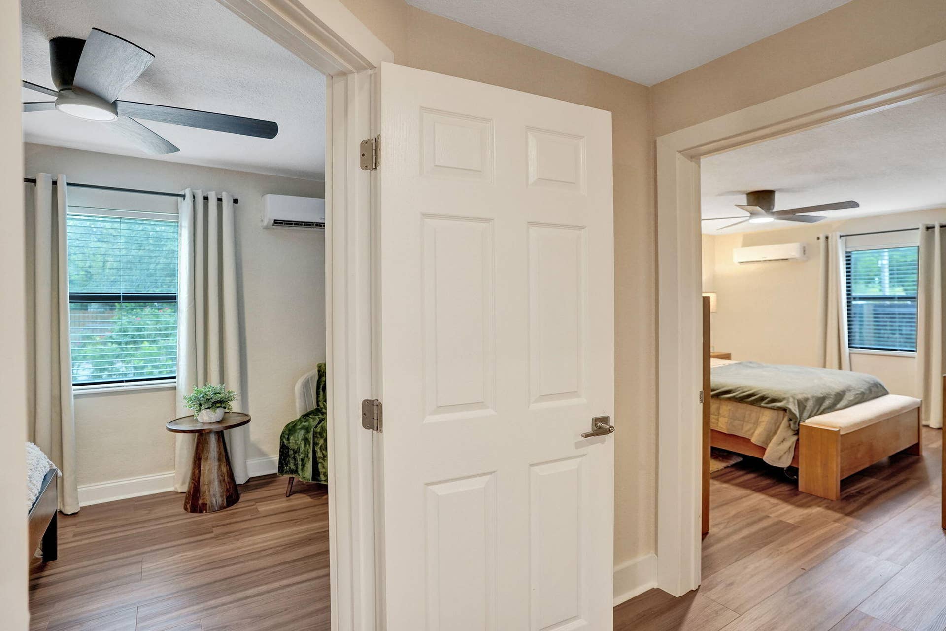 Wood-finish flooring throughout, with ceiling fans and individual wall-mounted climate control units in each room
