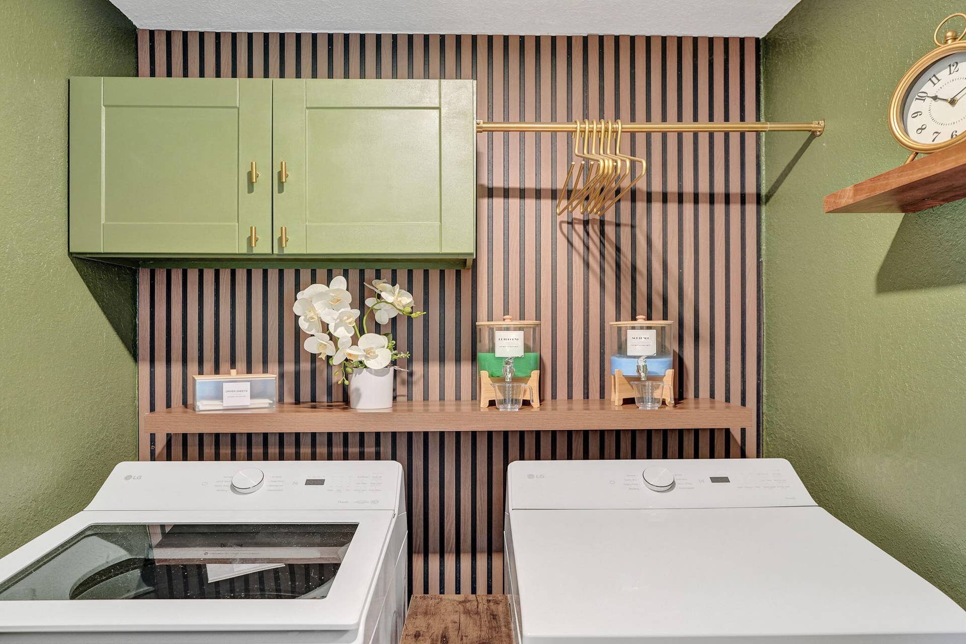 Interior laundry room with full size washer dryer and built in storage