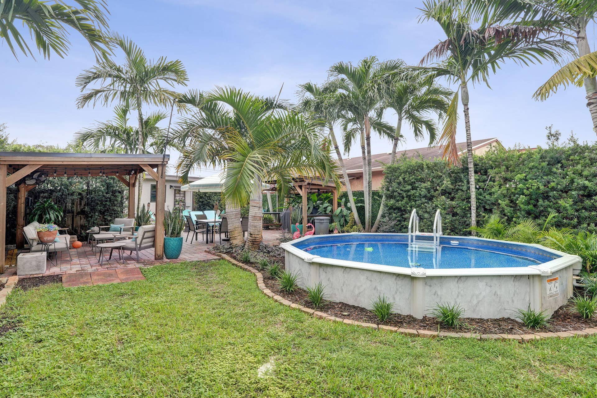 Expansive backyard with pergolas, pool and fire pit