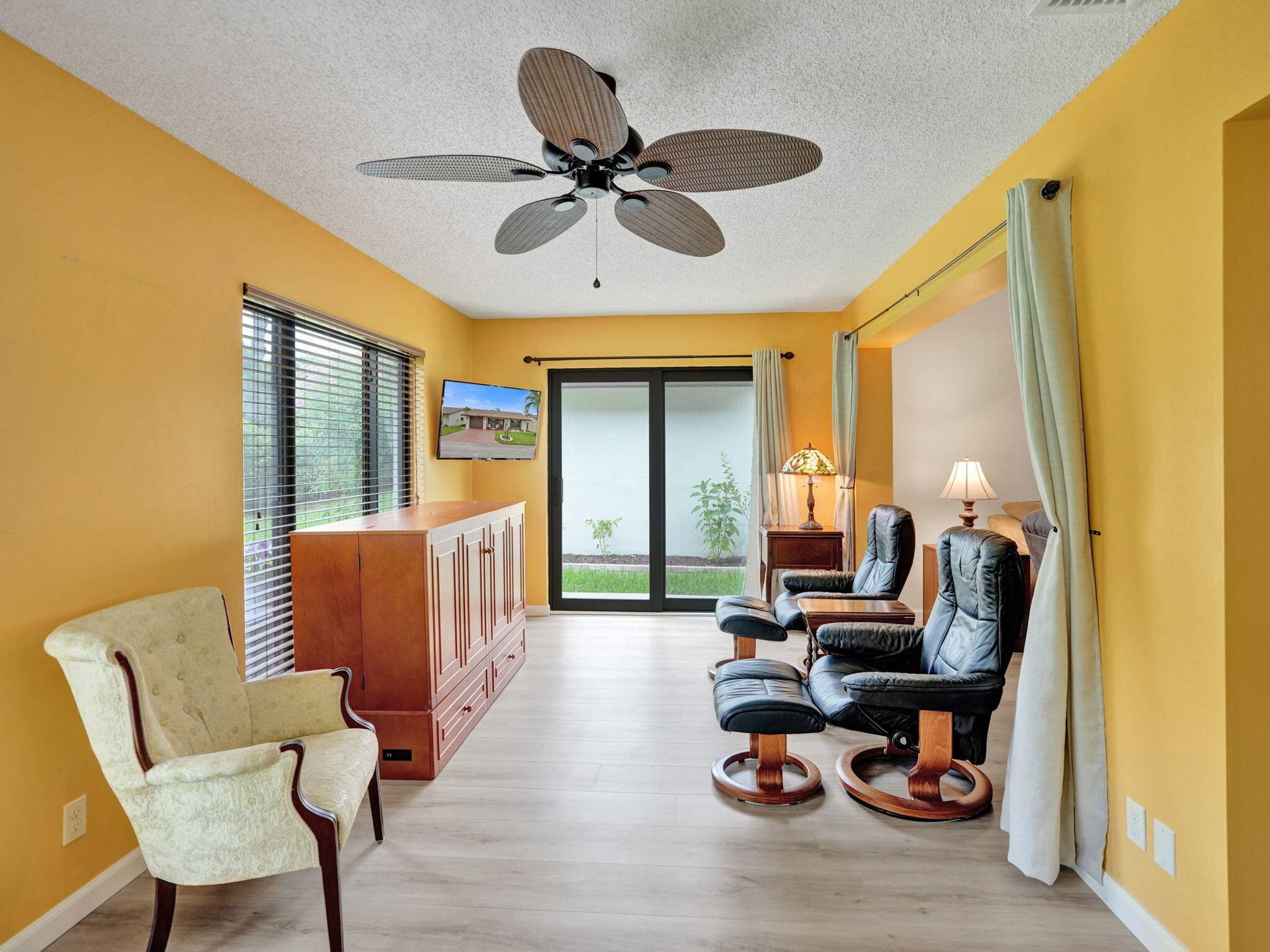 2085 SW 15th Place, Deerfield Beach, FL 33442 Wood-finish flooring, ceiling fan, and sliding glass door