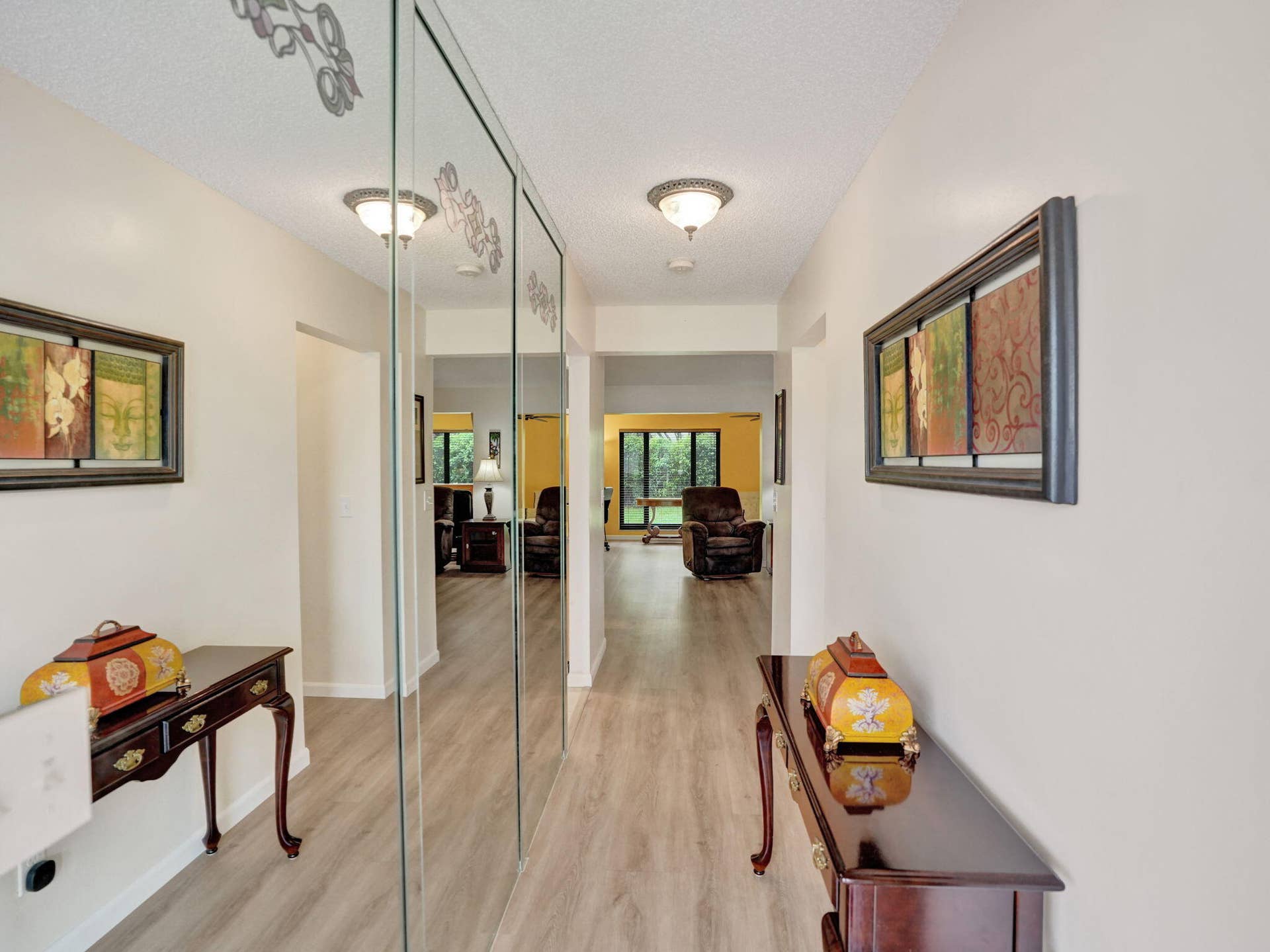2085 SW 15th Place, Deerfield Beach, FL 33442 Hallway featuring light wood-finish flooring and integrated mirrored panels