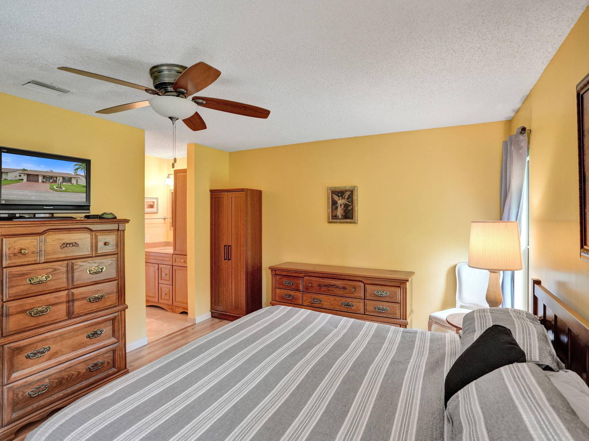 2085 SW 15th Place, Deerfield Beach, FL 33442 Laminate flooring, large room, two windows and a ceiling fan