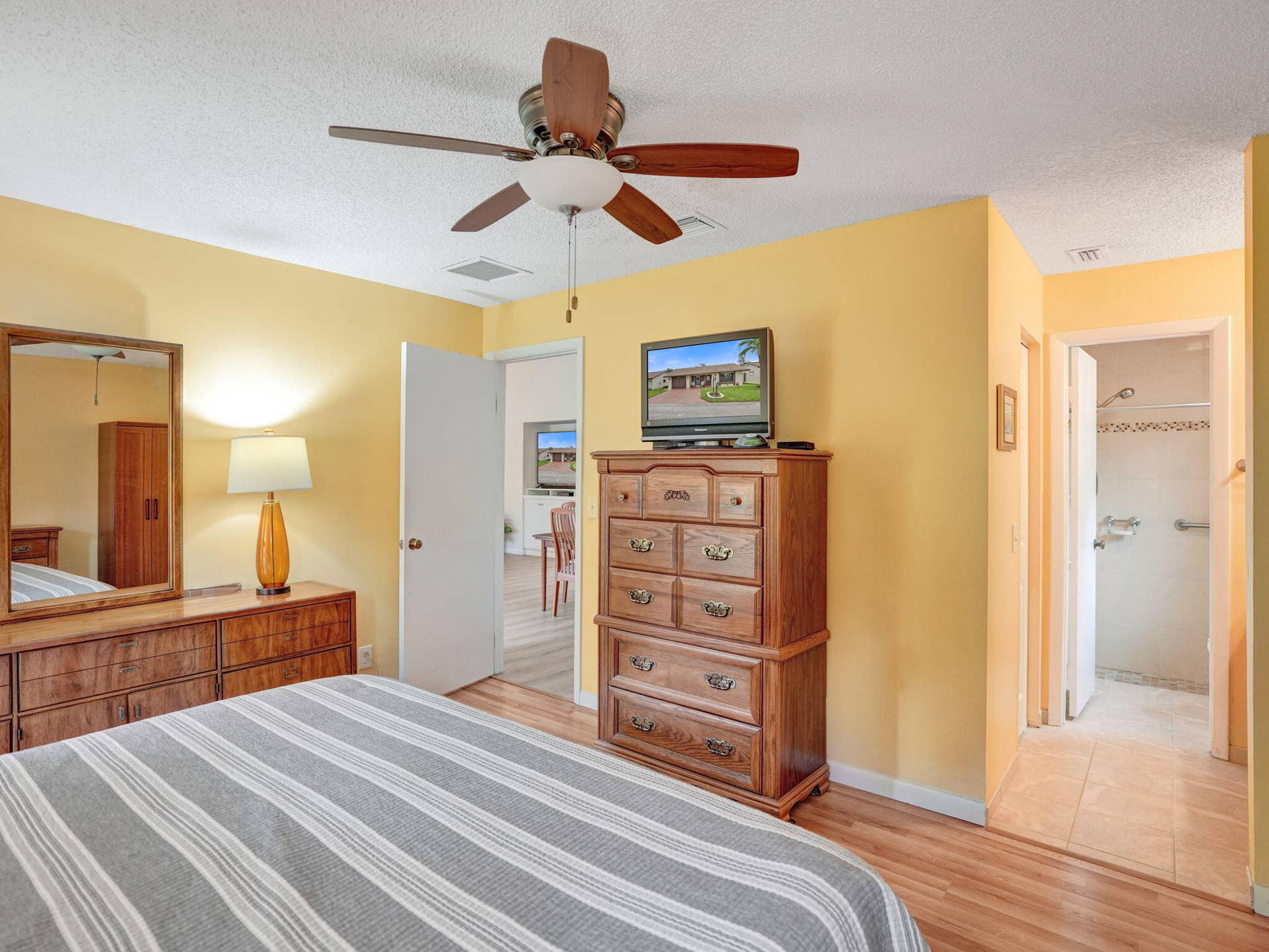 2085 SW 15th Place, Deerfield Beach, FL 33442 Laminate flooring, large room, two windows and a ceiling fan