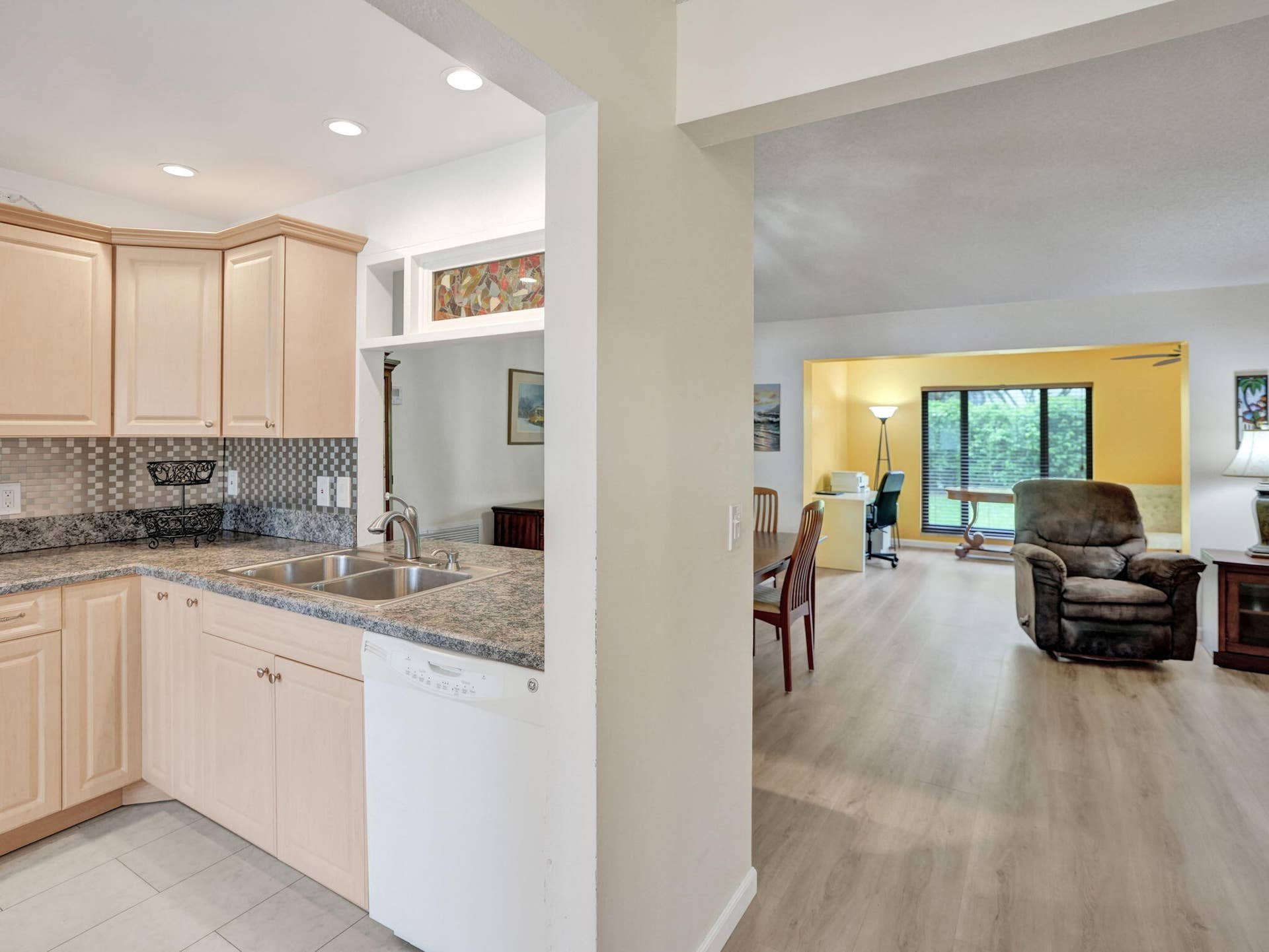 2085 SW 15th Place, Deerfield Beach, FL 33442 Kitchen featuring light-toned cabinetry, a mosaic tile backsplash, and a double basin sink