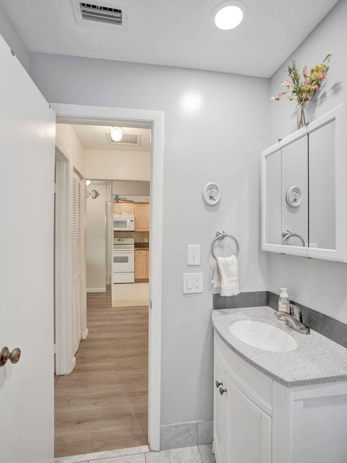 2085 SW 15th Place, Deerfield Beach, FL 33442 White vanity with a granite countertop and an integrated sink