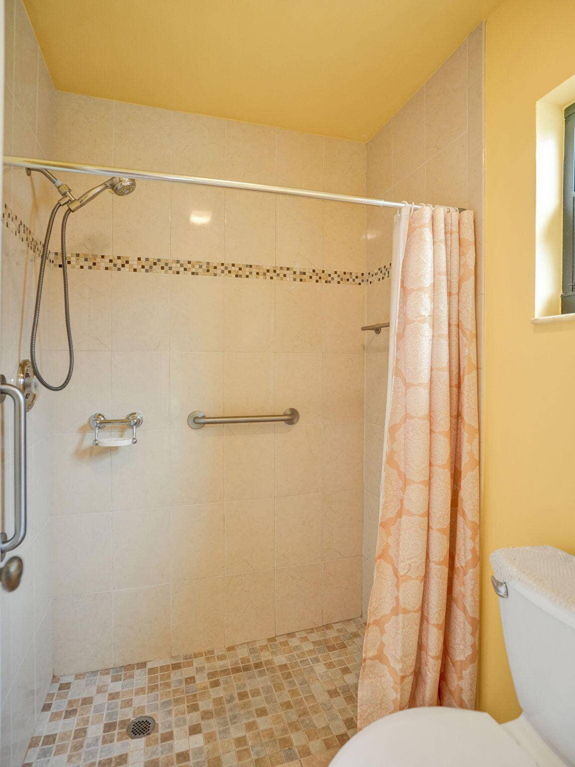 2085 SW 15th Place, Deerfield Beach, FL 33442 Updated primary shower featuring tiled walls, a decorative mosaic accent, mosaic tile flooring, a handheld showerhead, and grab bars.