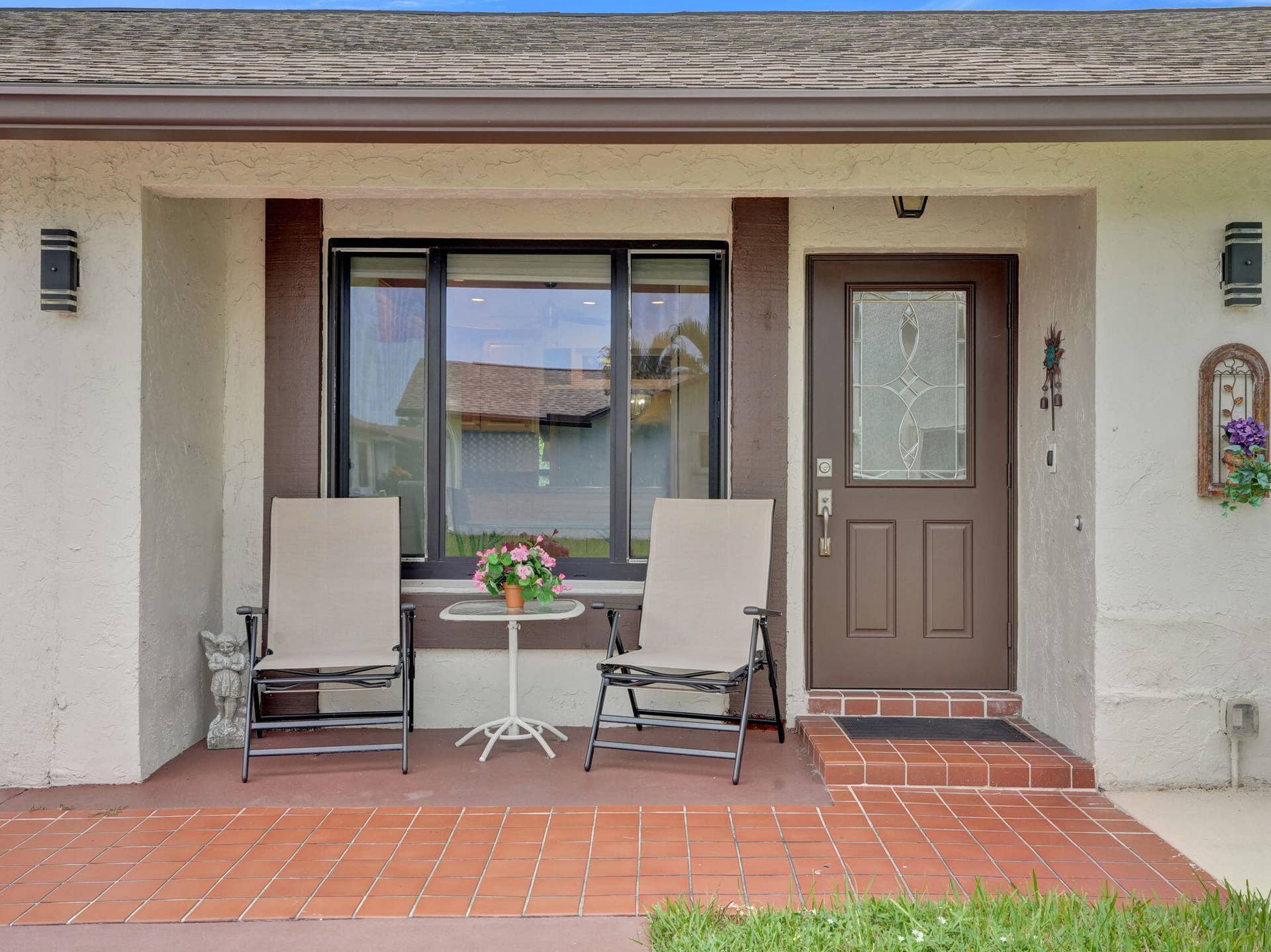 2085 SW 15th Place, Deerfield Beach, FL 33442 Tiled front porch entry with a decorative panel door and adjacent window