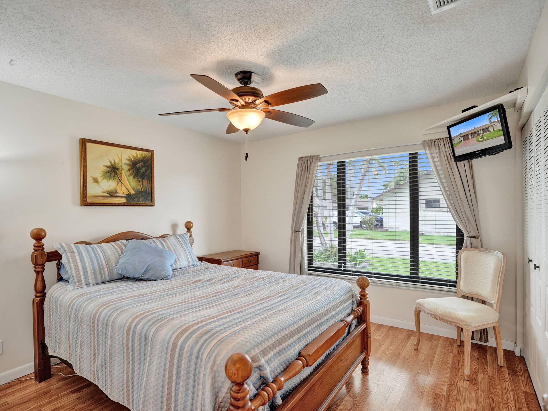 2085 SW 15th Place, Deerfield Beach, FL 33442 Wood-finish flooring throughout, ceiling fan with integrated lighting, and a large window with blinds