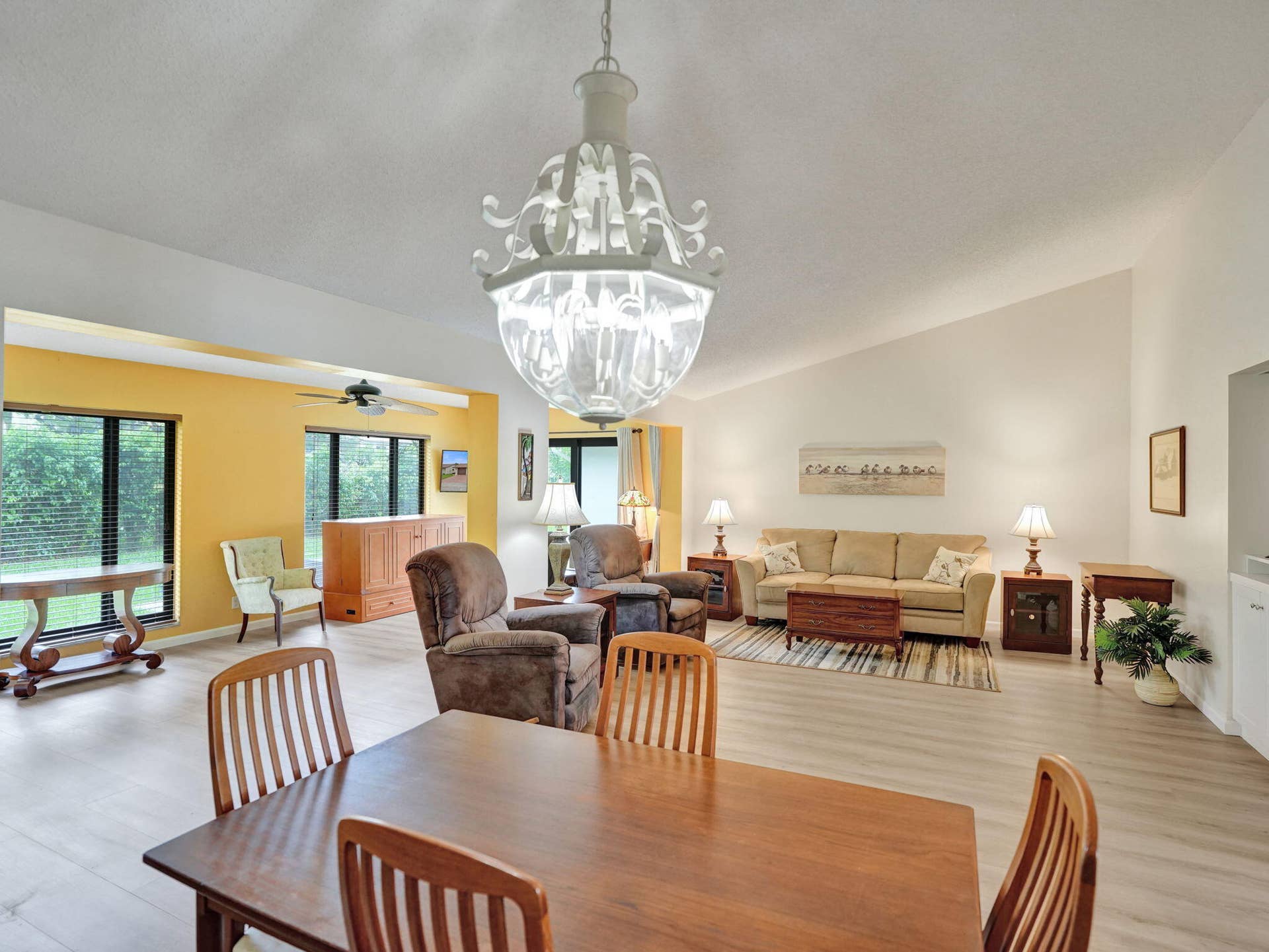 2085 SW 15th Place, Deerfield Beach, FL 33442 Vaulted ceiling, decorative chandelier, wood-finish flooring, multiple window exposures, ceiling fan