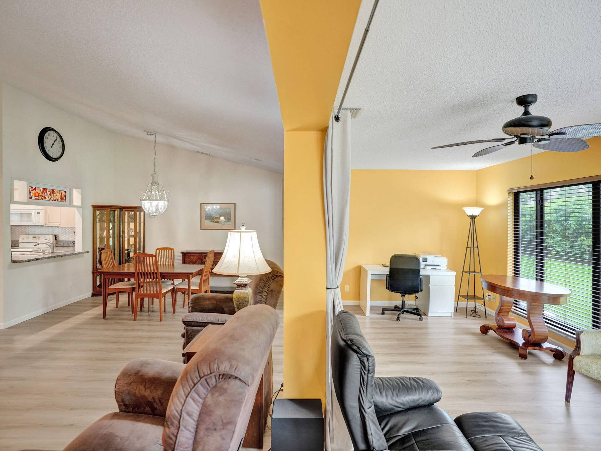 2085 SW 15th Place, Deerfield Beach, FL 33442 Vaulted ceilings, wood-finish flooring, kitchen pass-through, and a ceiling fan