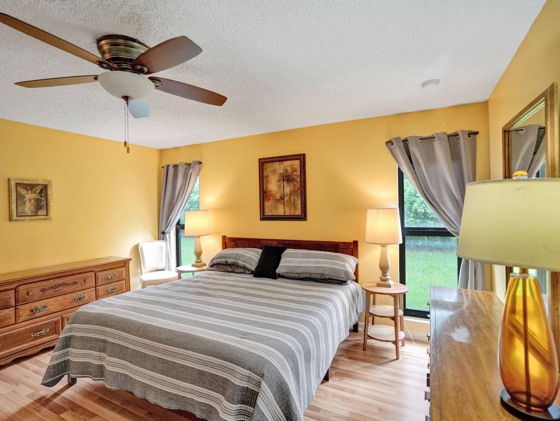 2085 SW 15th Place, Deerfield Beach, FL 33442 Laminate flooring, large room, two windows and a ceiling fan