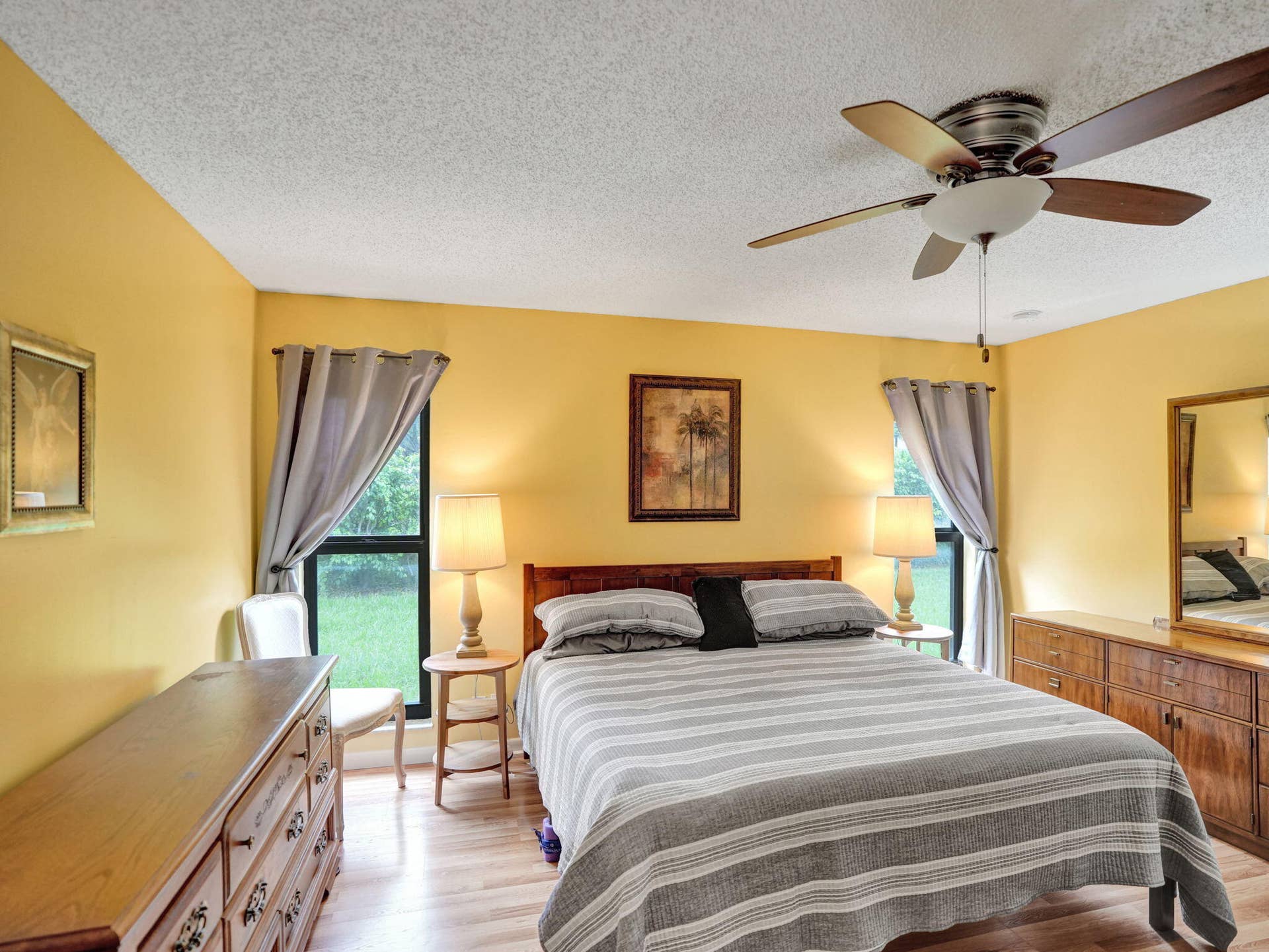 2085 SW 15th Place, Deerfield Beach, FL 33442 Laminate flooring, large room, two windows and a ceiling fan