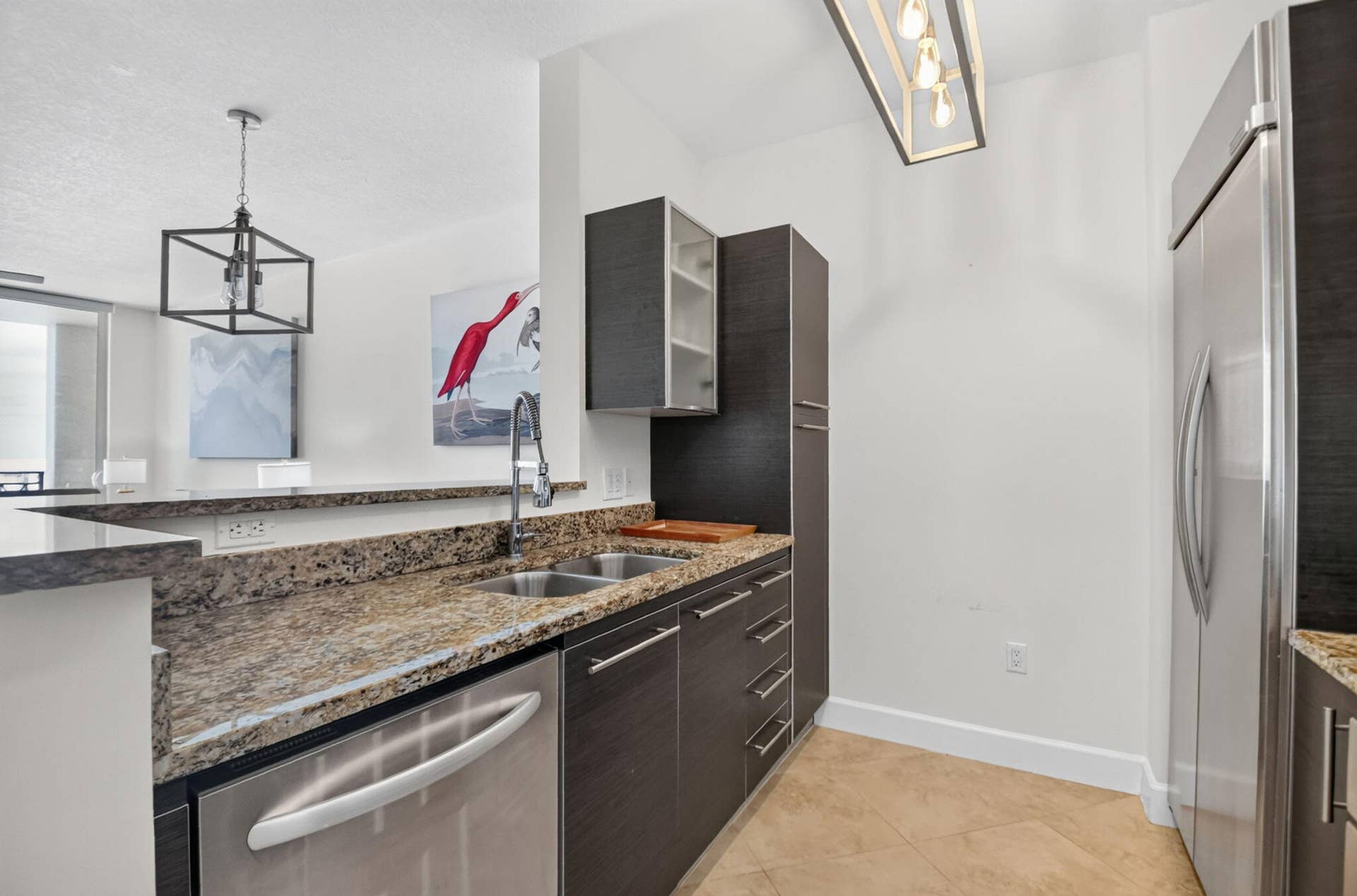 550 OKEECHOBEE Boulevard, #1618, West Palm Beach, West Palm Beach, FL 33401 Kitchen featuring dark wood-finish cabinetry, granite countertops, a stainless steel dishwasher, and a double-basin sink