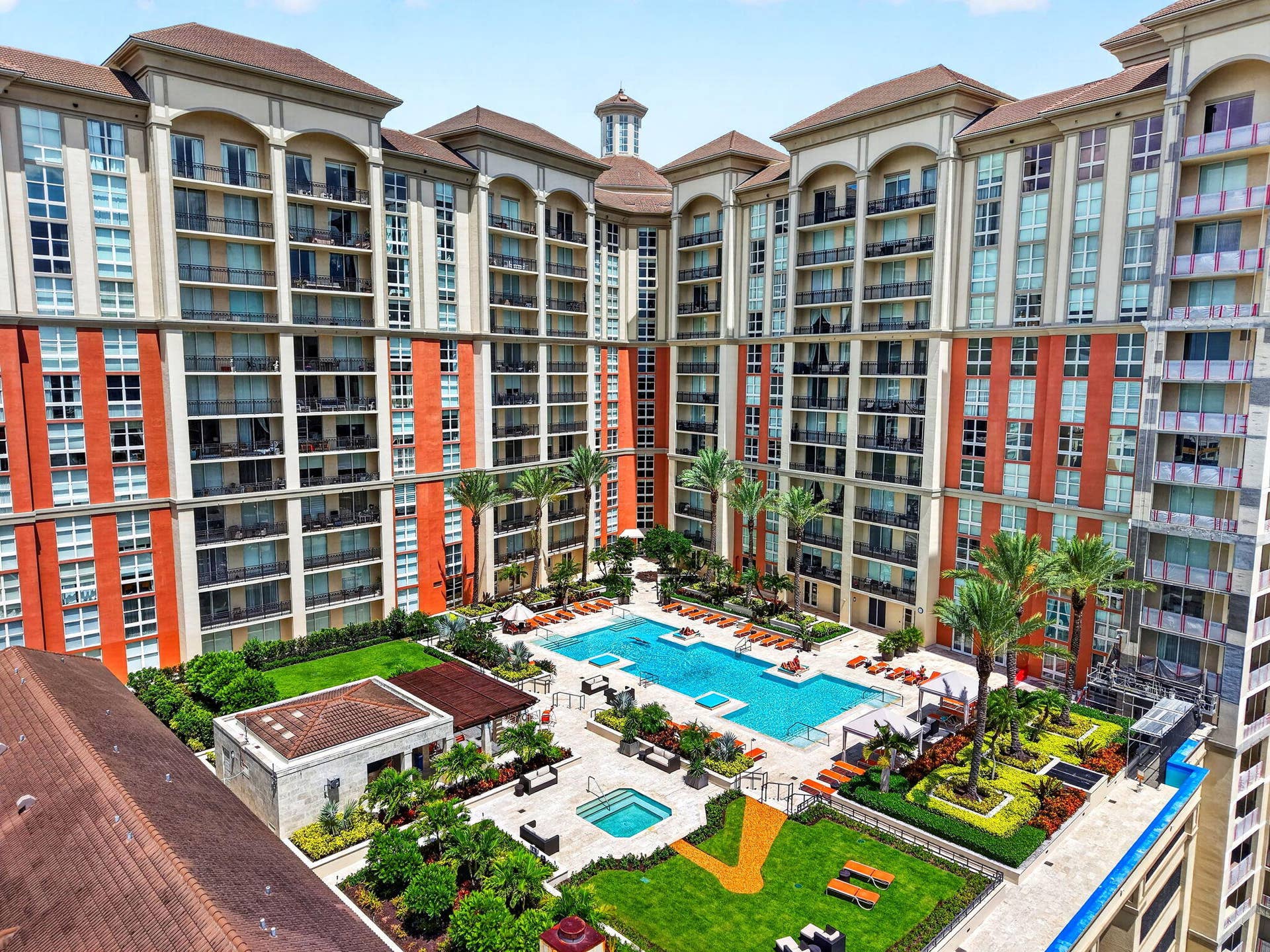550 OKEECHOBEE Boulevard, #1618, West Palm Beach, West Palm Beach, FL 33401 Multi-story building featuring numerous balconies, a central courtyard, multiple swimming pools, a spa, and landscaped green spaces