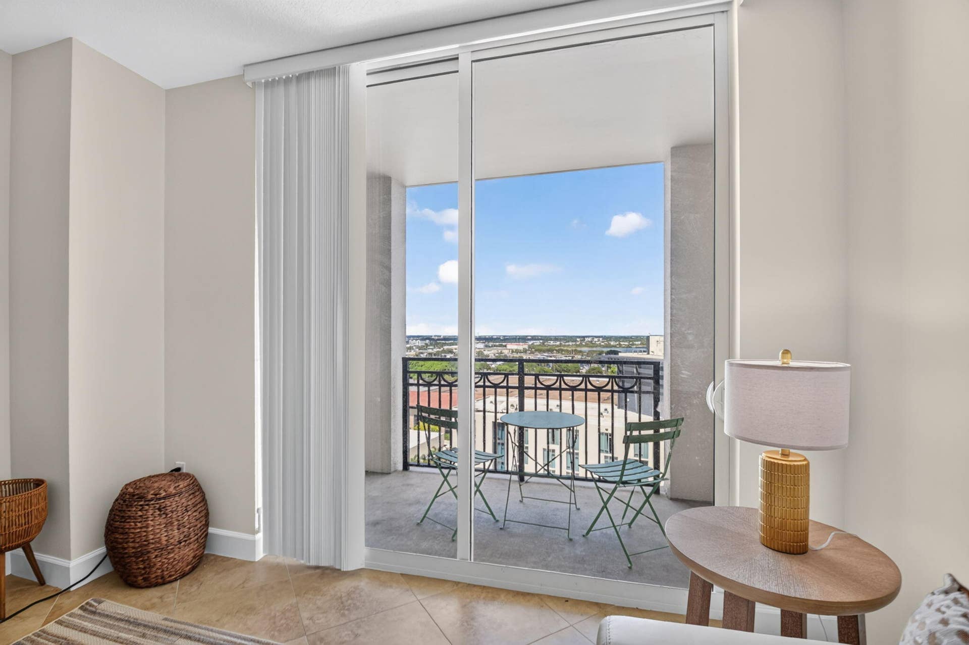 550 OKEECHOBEE Boulevard, #1618, West Palm Beach, West Palm Beach, FL 33401 Sliding glass doors opening to a private balcony with a wrought iron railing, concrete flooring, and a city panorama