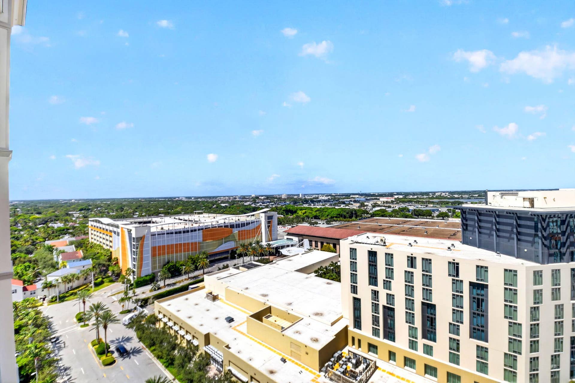 550 OKEECHOBEE Boulevard, #1618, West Palm Beach, West Palm Beach, FL 33401 Expansive urban scenery with diverse architectural styles, featuring multiple commercial buildings, and a clear horizon line