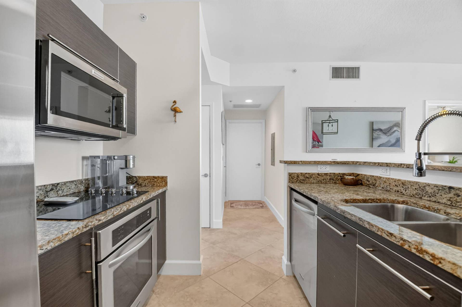 550 OKEECHOBEE Boulevard, #1618, West Palm Beach, West Palm Beach, FL 33401 Stainless steel microwave, integrated cooktop, stainless steel oven, stone countertops, and a dual basin stainless steel sink