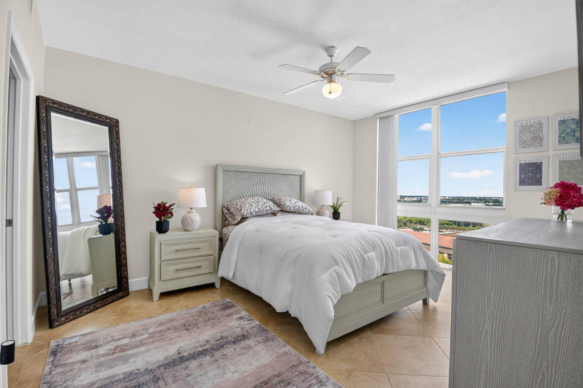 550 OKEECHOBEE Boulevard, #1618, West Palm Beach, West Palm Beach, FL 33401 Expansive window wall, tile flooring, ceiling fan with integrated lighting, and neutral wall tones