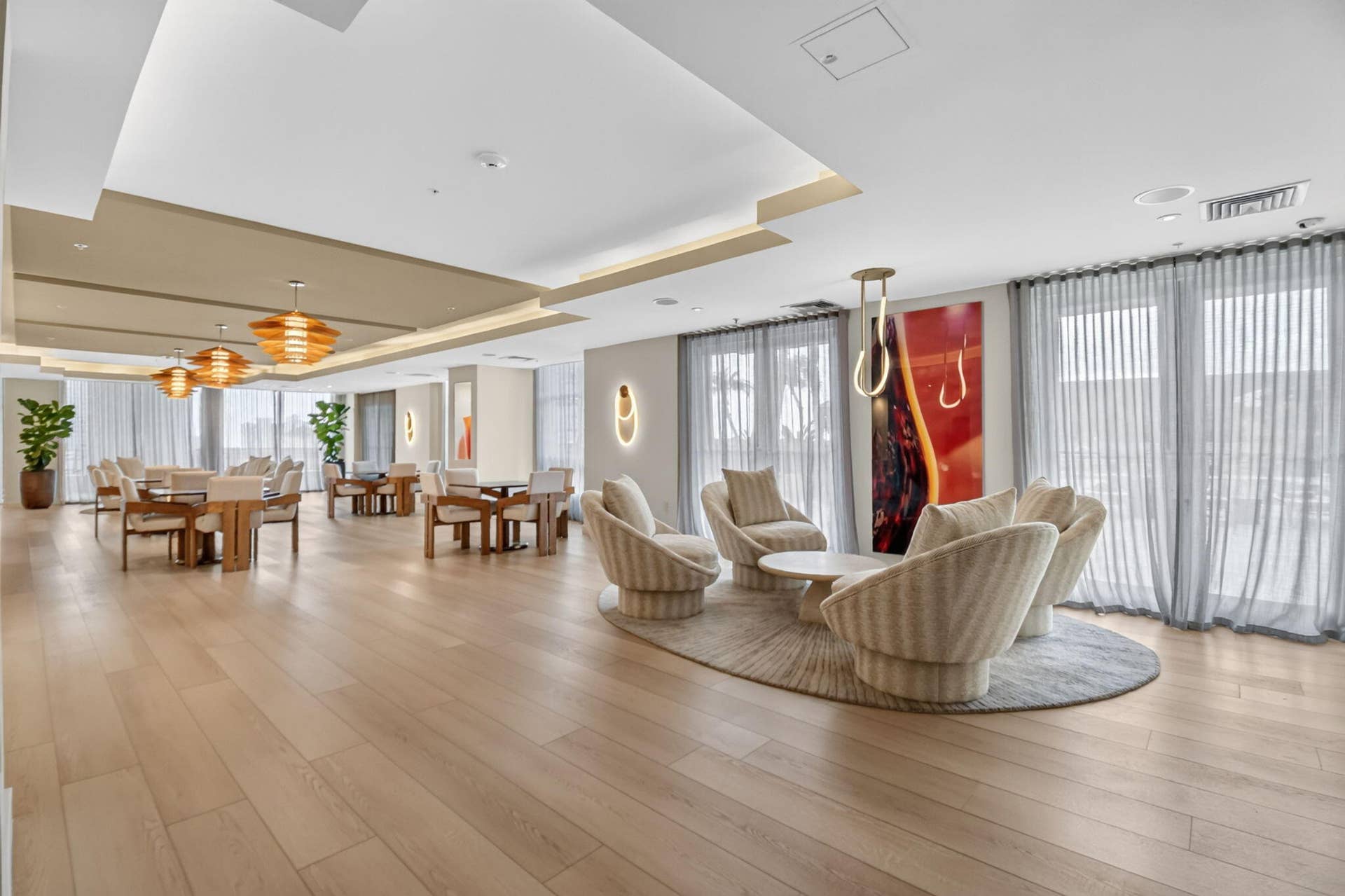 550 OKEECHOBEE Boulevard, #1618, West Palm Beach, West Palm Beach, FL 33401 Sophisticated open-concept lounge featuring light wood-finish flooring, soaring ceilings with recessed lighting, and expansive floor-to-ceiling windows with vertical blinds