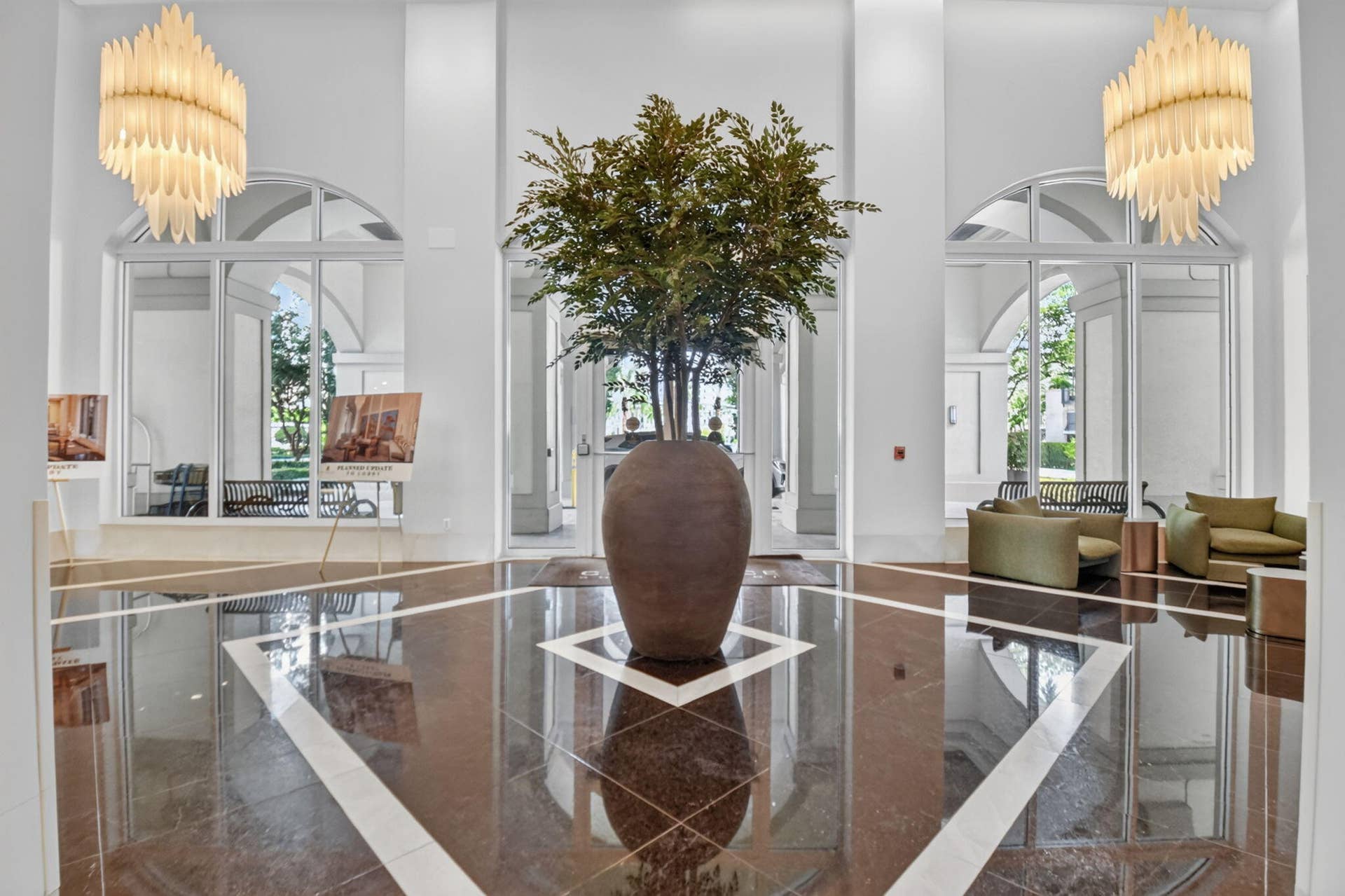 550 OKEECHOBEE Boulevard, #1618, West Palm Beach, West Palm Beach, FL 33401 Polished marble flooring with geometric inlay, arched transom windows, two multi-tiered chandeliers, and high ceilings