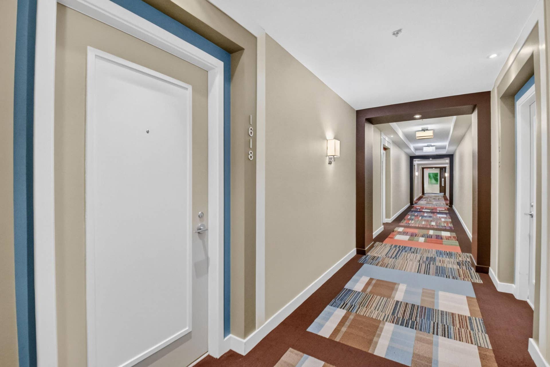 550 OKEECHOBEE Boulevard, #1618, West Palm Beach, West Palm Beach, FL 33401 Entry door with modern hardware, architectural wall sconces, recessed ceiling lights, and patterned hallway runner